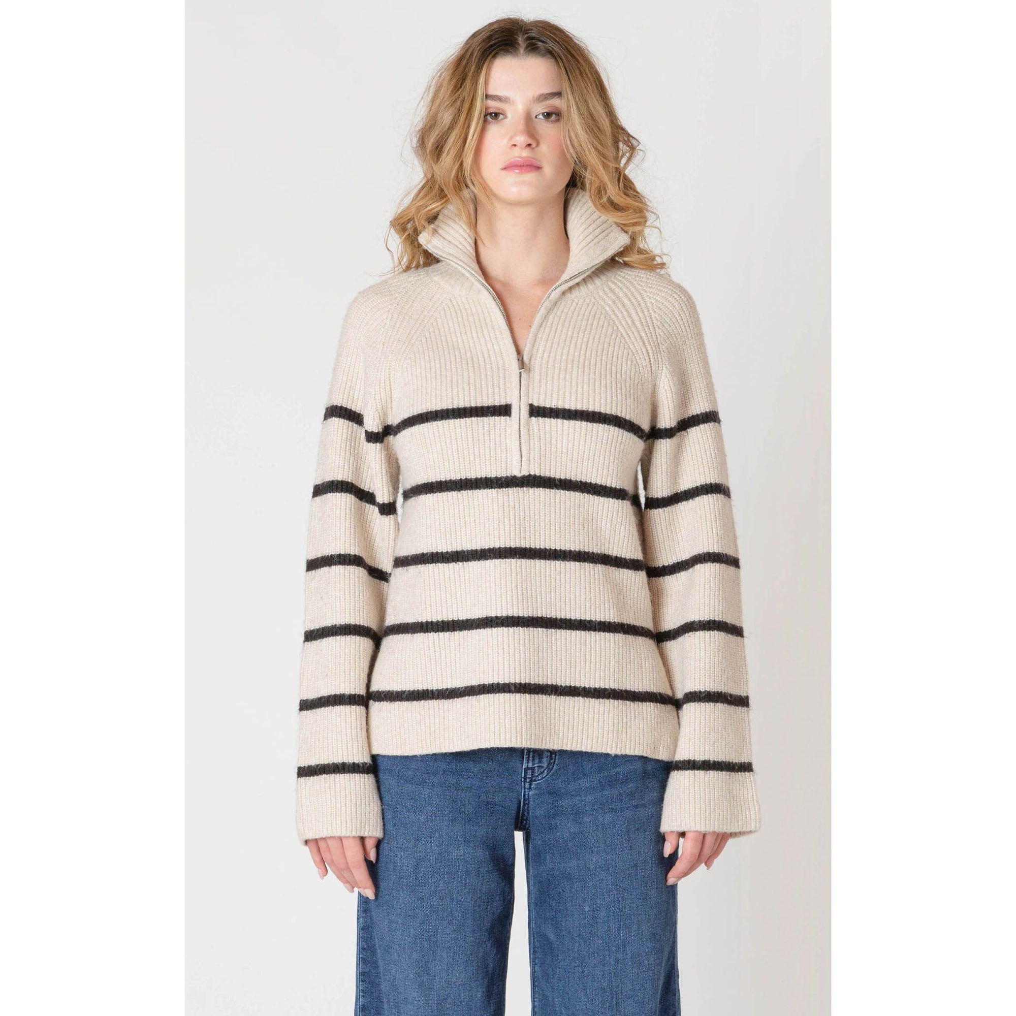 Beige oatmeal Room 34 half-zip longline sweater with bold black stripes on a model.