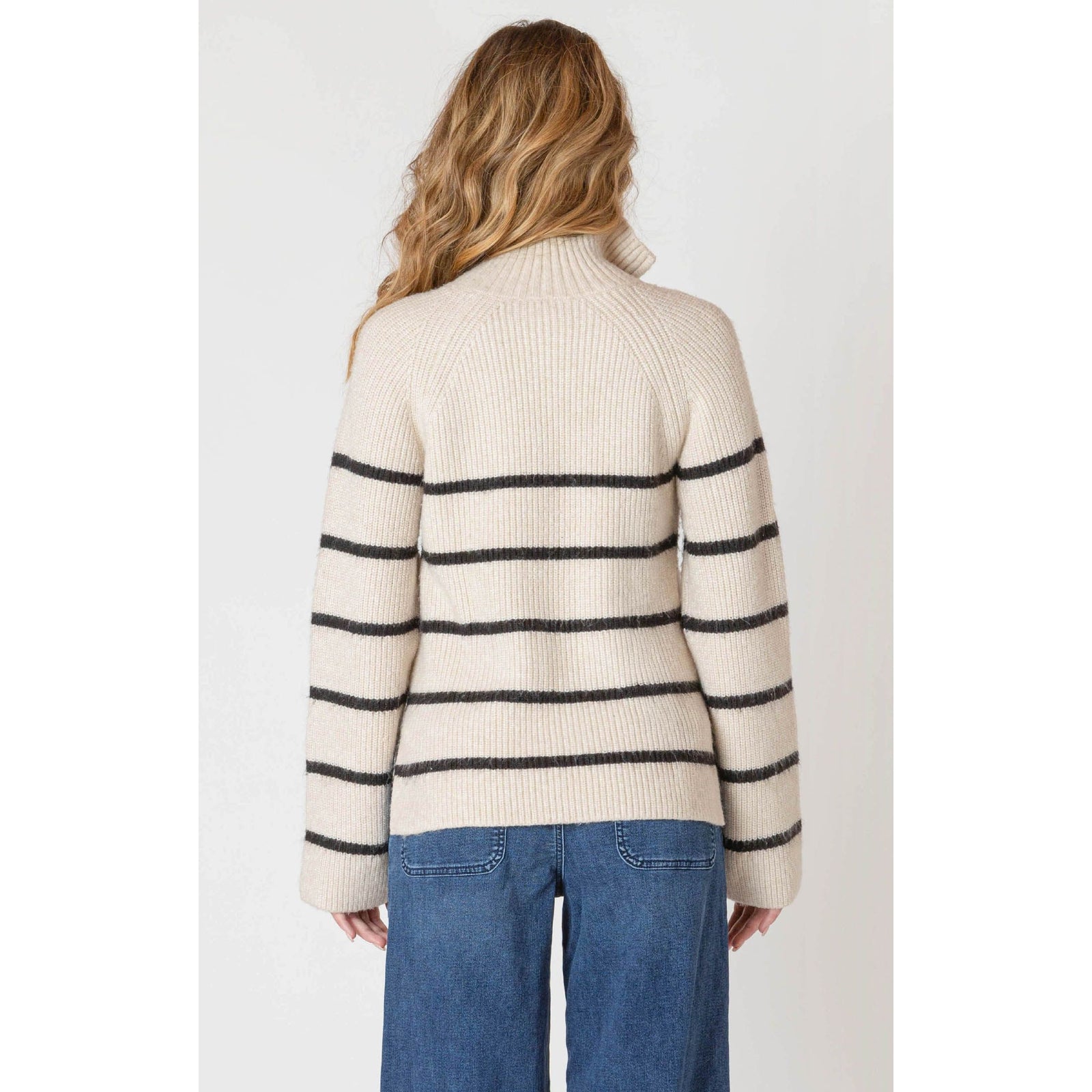 Beige oatmeal Room 34 half-zip longline sweater with bold black stripes on a model.