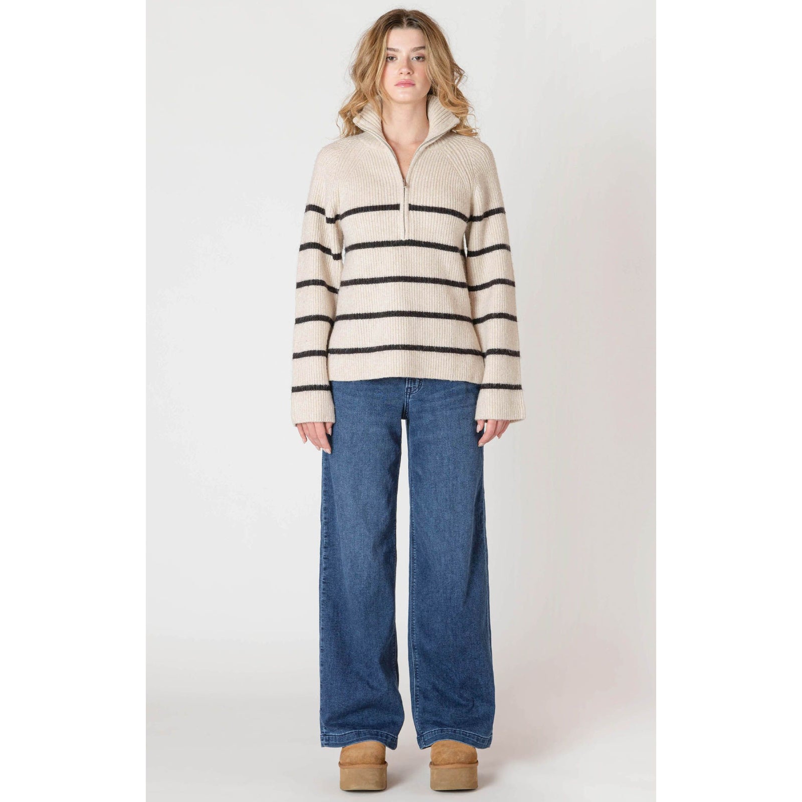 Room 34 Half Zip Longline Sweater in oatmeal with bold black stripes worn with wide-leg denim.