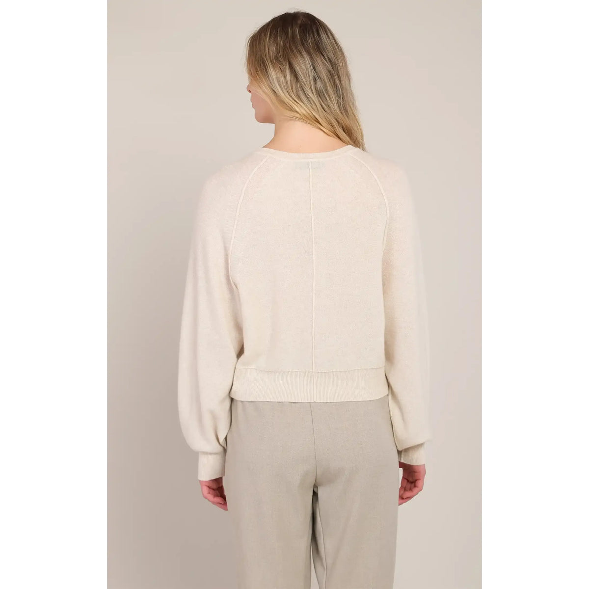 Back view of cream Henley sweater with raglan sleeves and ribbed hem, offering warm, everyday comfort for casual wear.