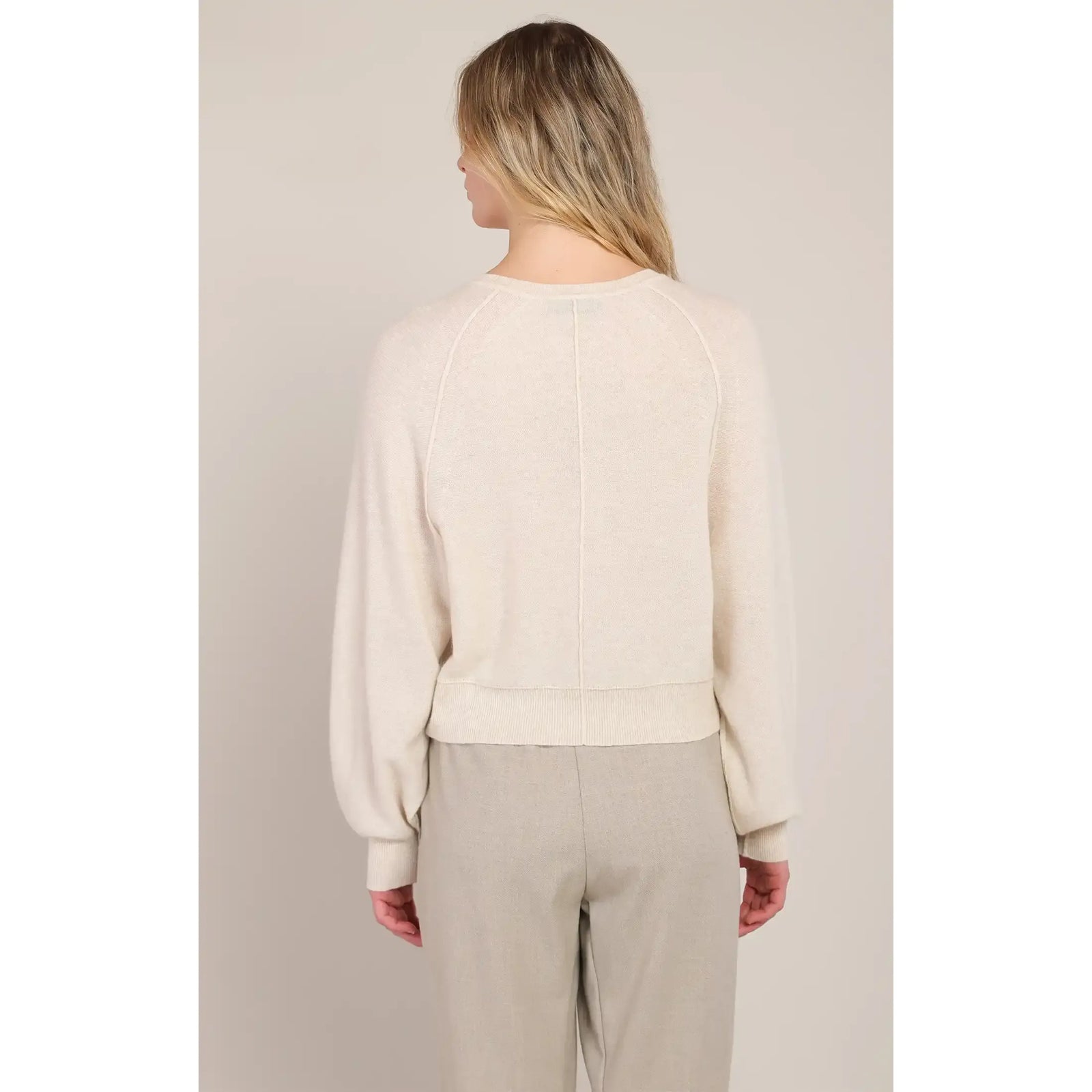 Back view of cream Henley sweater with raglan sleeves and ribbed hem, offering warm, everyday comfort for casual wear.