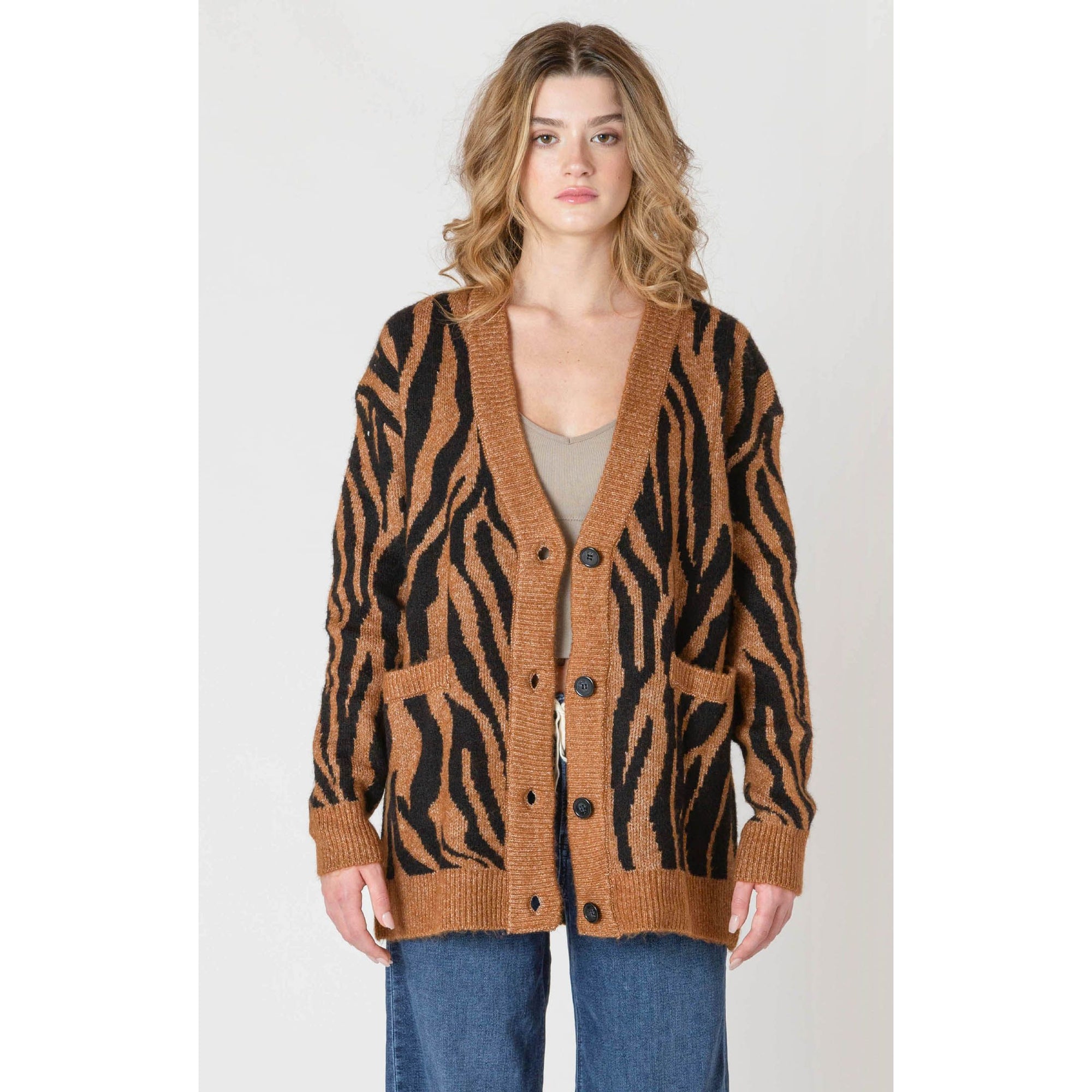 Room 34 Print Cardigan in tiger print, oversized knit worn open over a beige crop top.