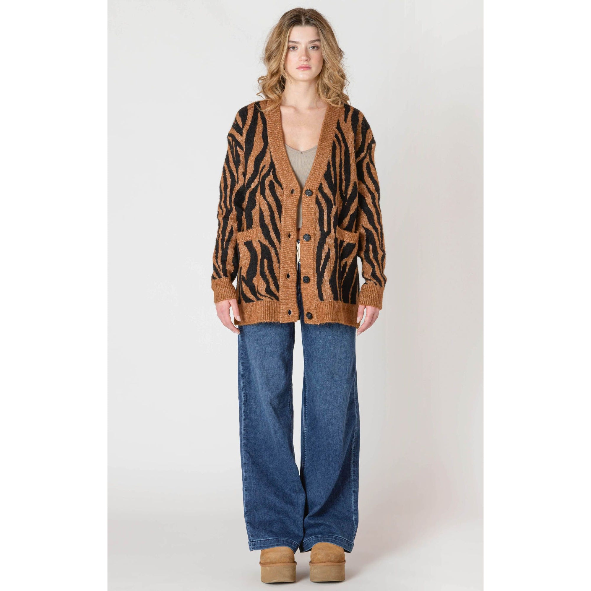 Room 34 Print Cardigan featuring tiger print, oversized fit, V-neck with button closure and pockets, worn with jeans.