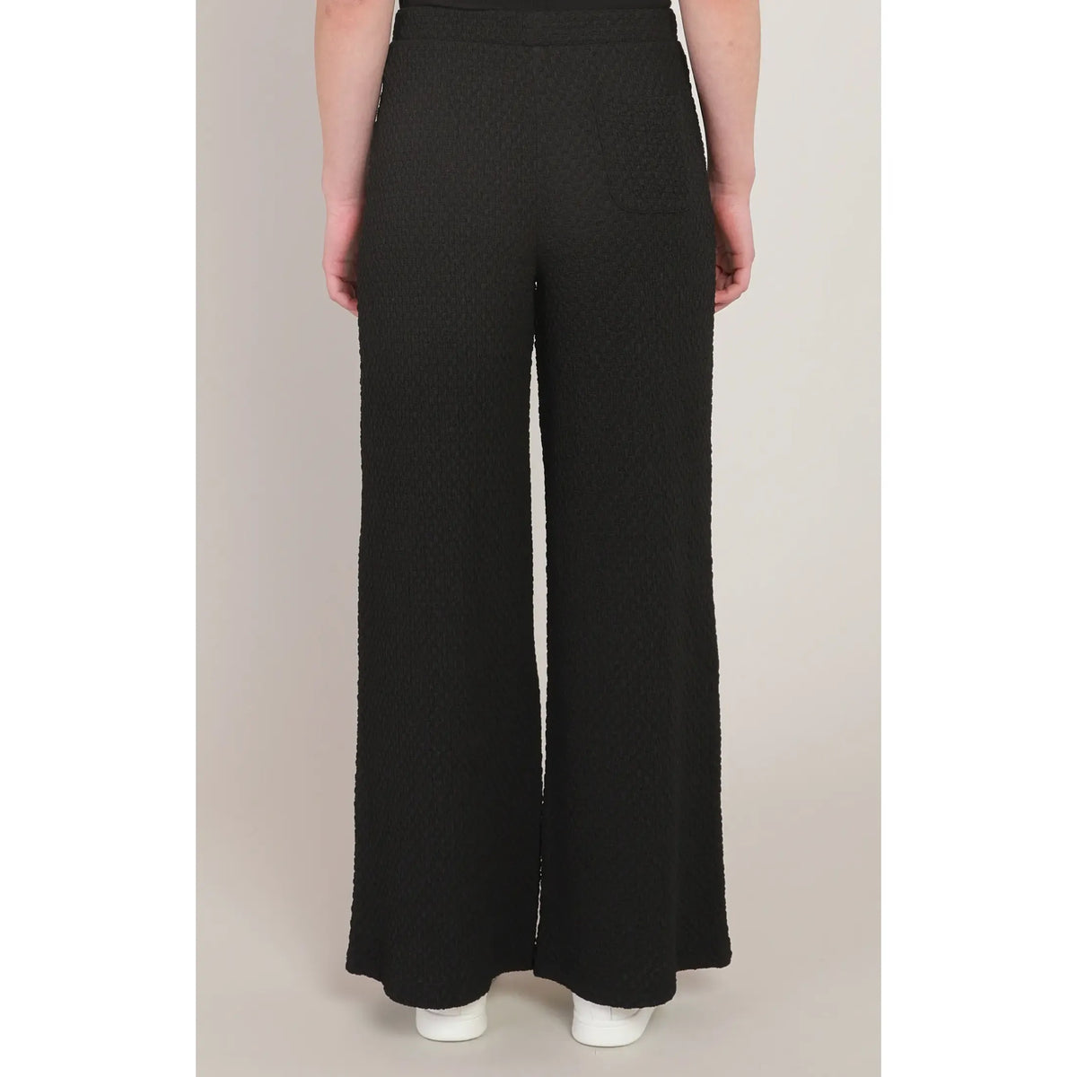 Black textured wide leg pants with a mid-rise fit and rear pocket, offering chic style and all-day comfort.