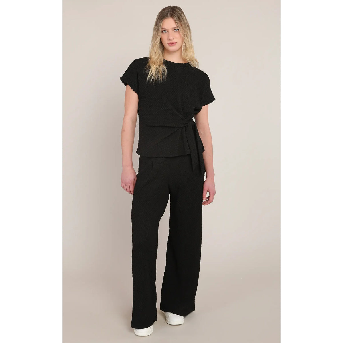 Black textured wide leg pants with a mid-rise fit, offering chic style and all-day comfort.