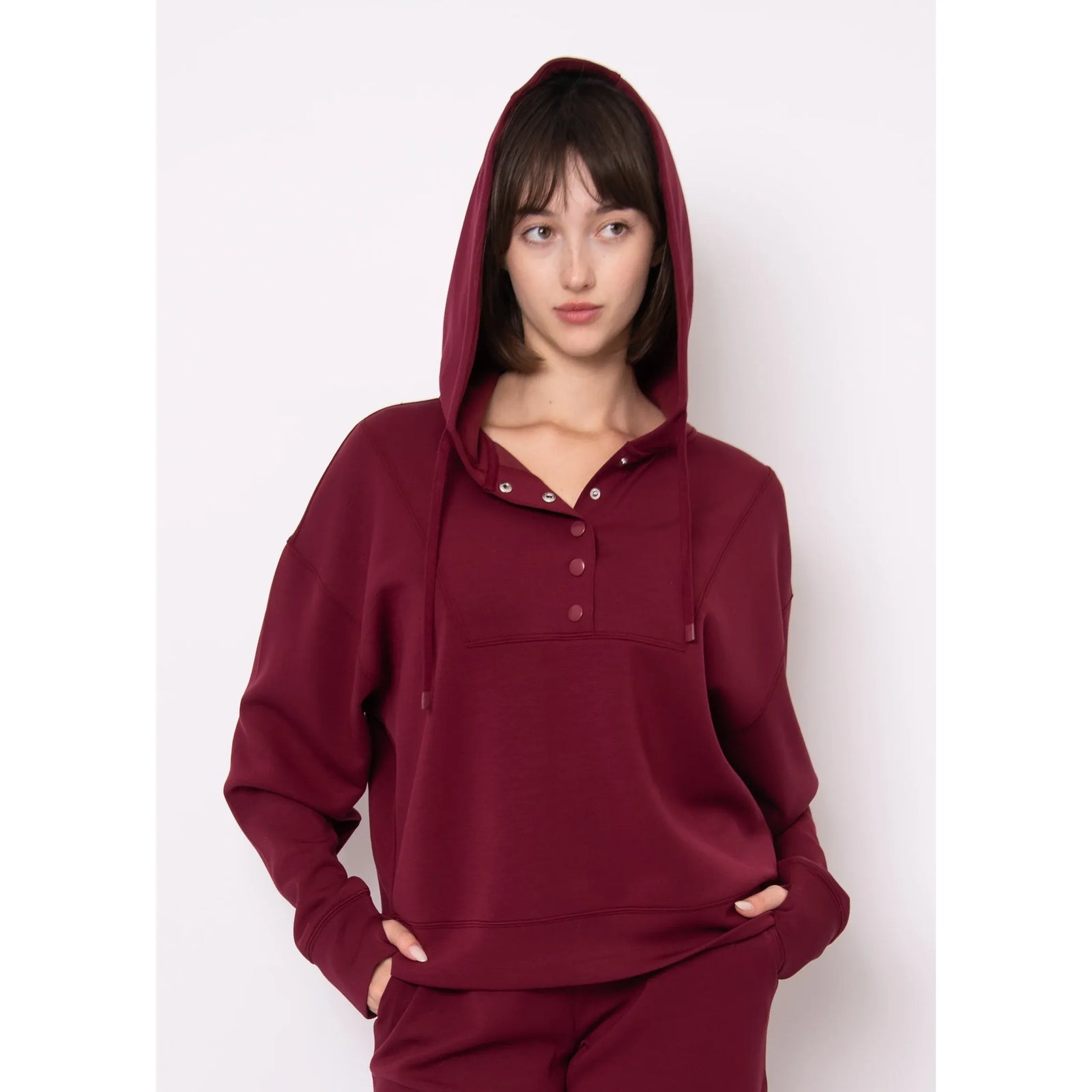 Burgundy Sallie Soft Knit Snap Front Hoodie with hood up on a model.