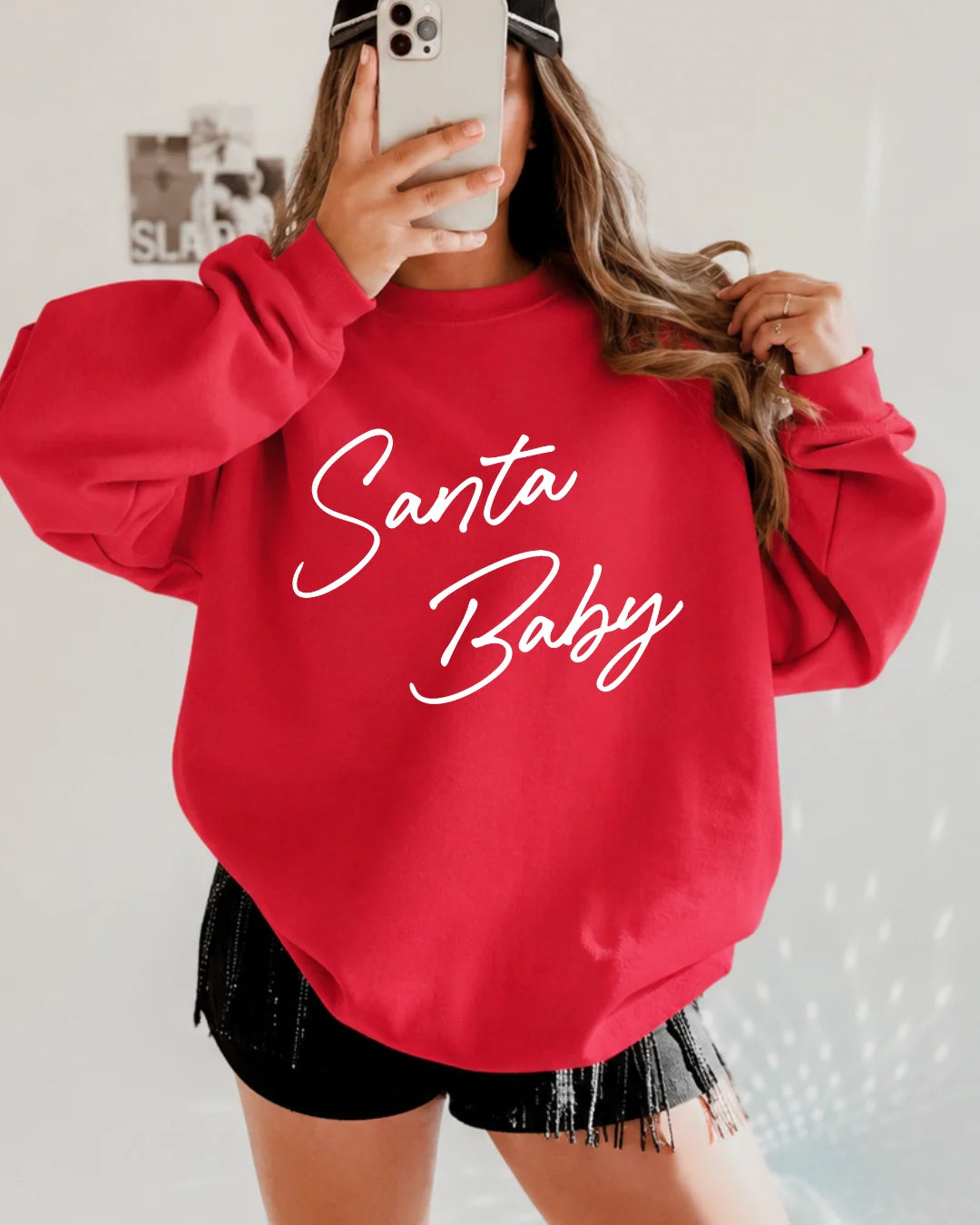 Red Santa Baby crewneck sweatshirt featuring white script text across the chest for a festive and flirty holiday look.