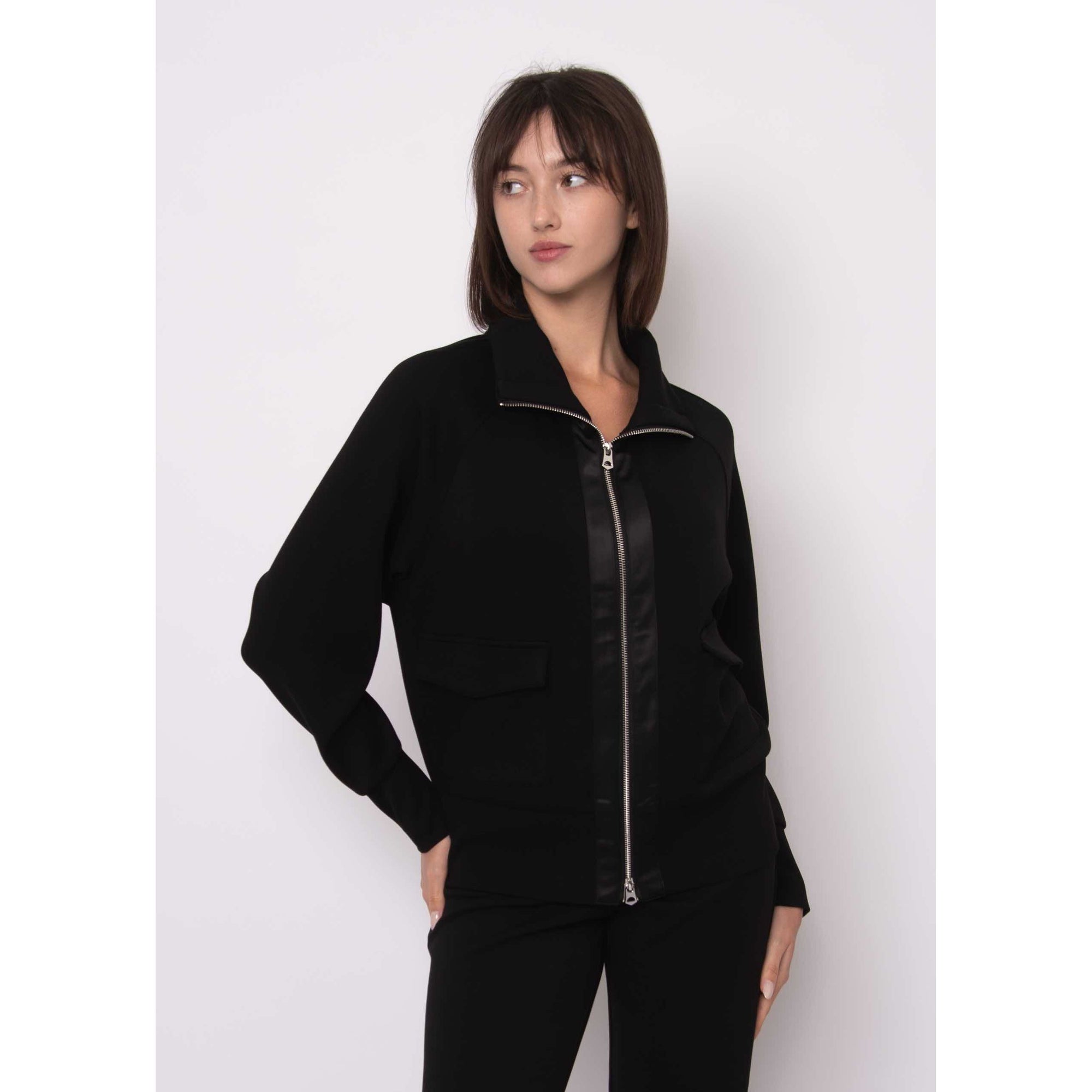 Saruna Soft Knit Mock Zip Up in black with satin-trim zipper, worn by a model.