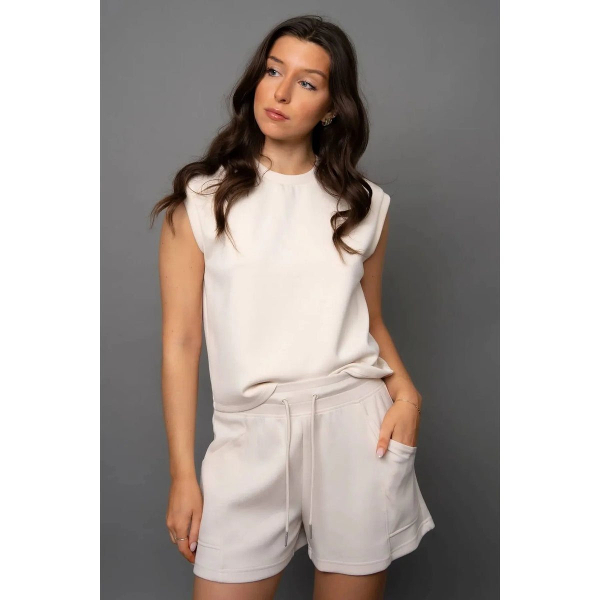 Creamery: Scuba Senza Soft Knit Shorts in cream with pockets; model Sharlen wearing size small.