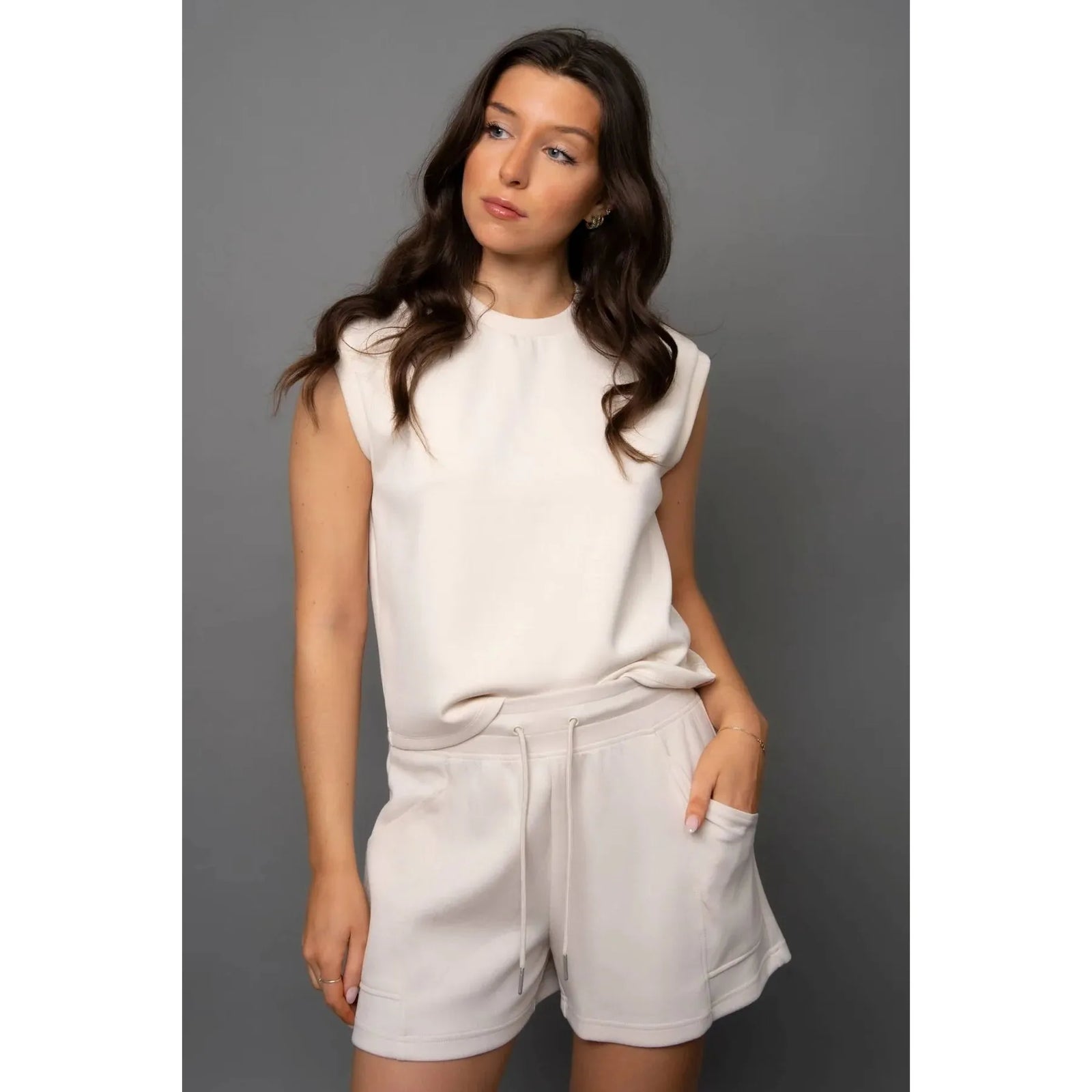 Creamery: Scuba Senza Soft Knit Shorts in cream with pockets; model Sharlen wearing size small.