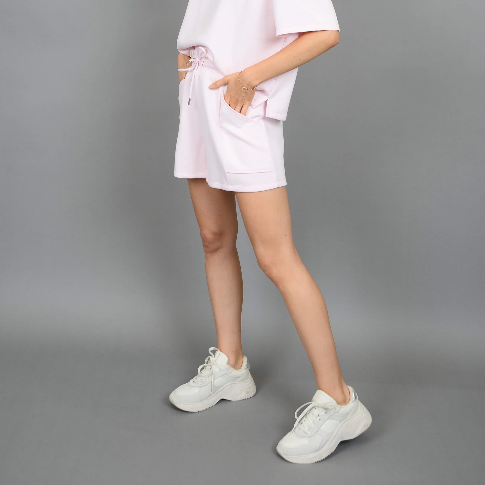 Scuba Senza Soft Knit Shorts on model Sharlen (5 ft 6), pink lounge shorts with pockets and a matching top option