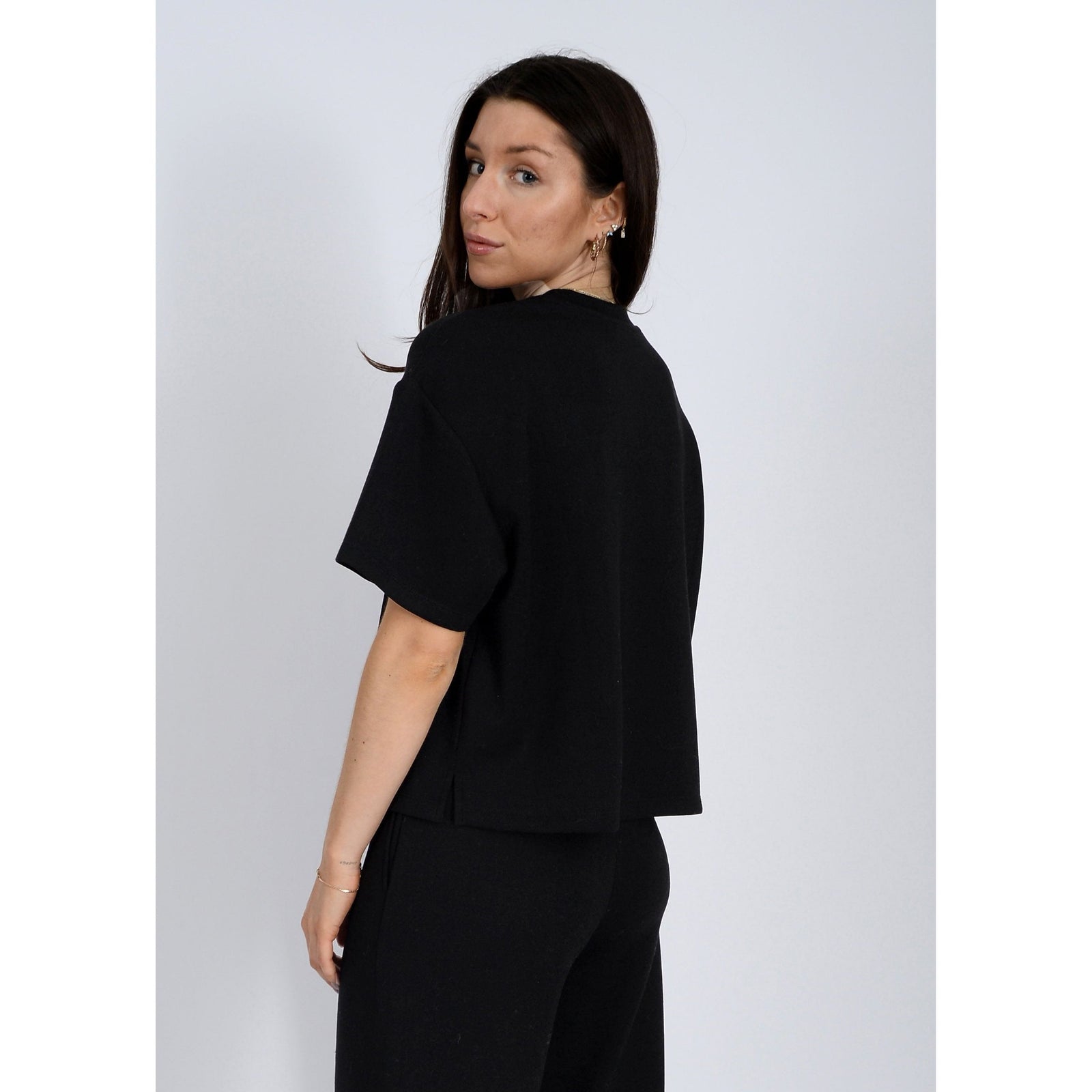 Stylish Scuba Tess Soft Knit Top in black, perfect for a casual look or pairing with denim for added comfort.