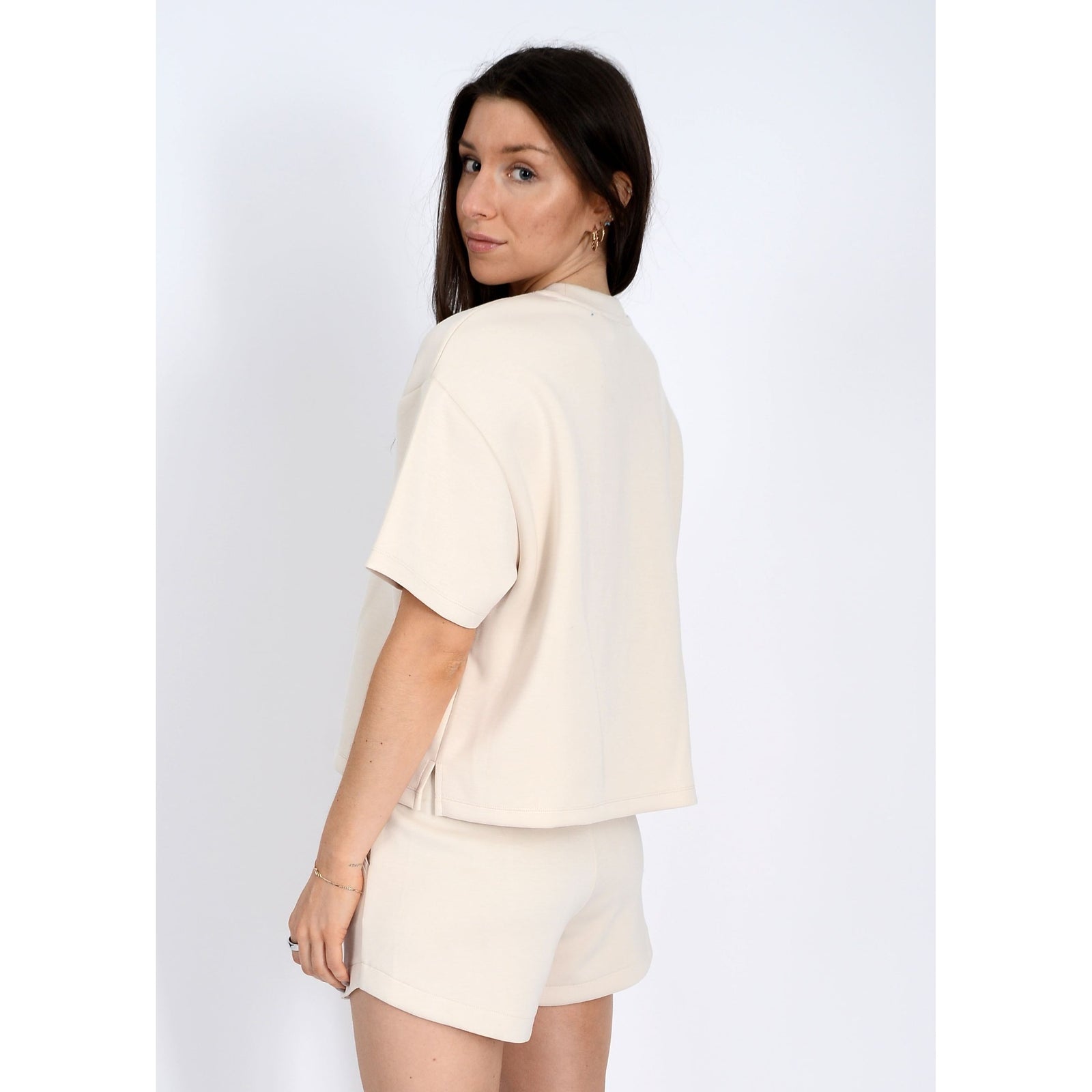 Stylish model wearing the Scuba Tess Soft Knit Top, showcasing its comfy fit and versatile style for any occasion.