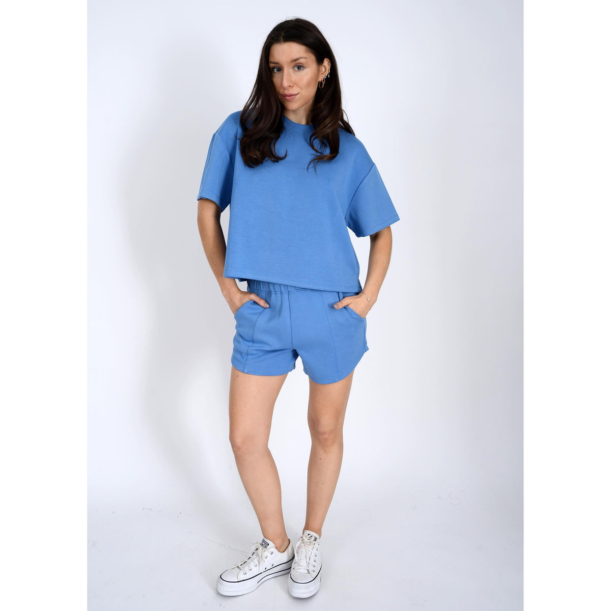 Stylish model showcasing the Scuba Tess Soft Knit Top, paired with matching shorts for a comfy look.