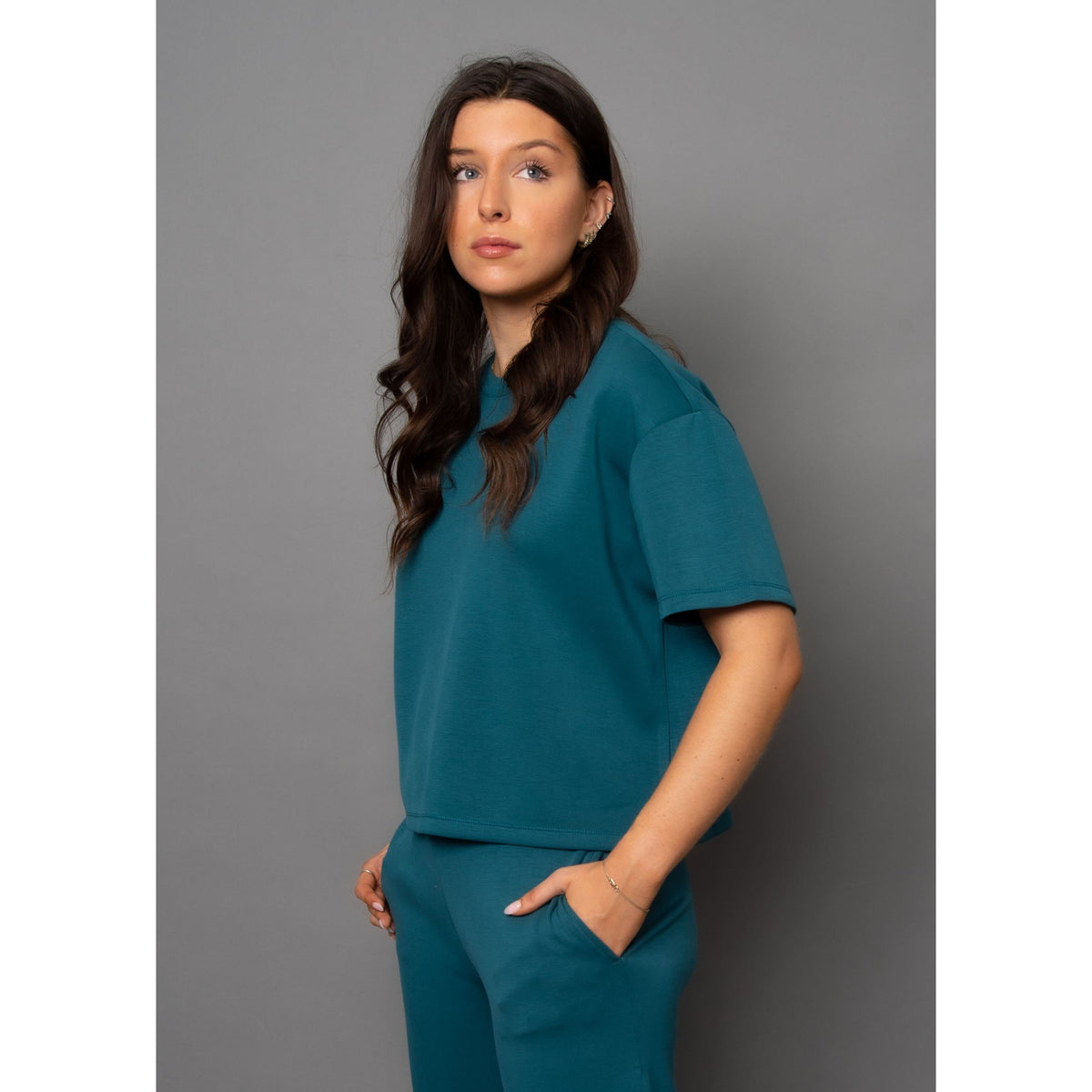 Stylish model showcases the Scuba Tess Soft Knit Top in Trekking Green, perfect for casual outfits or cute sets.