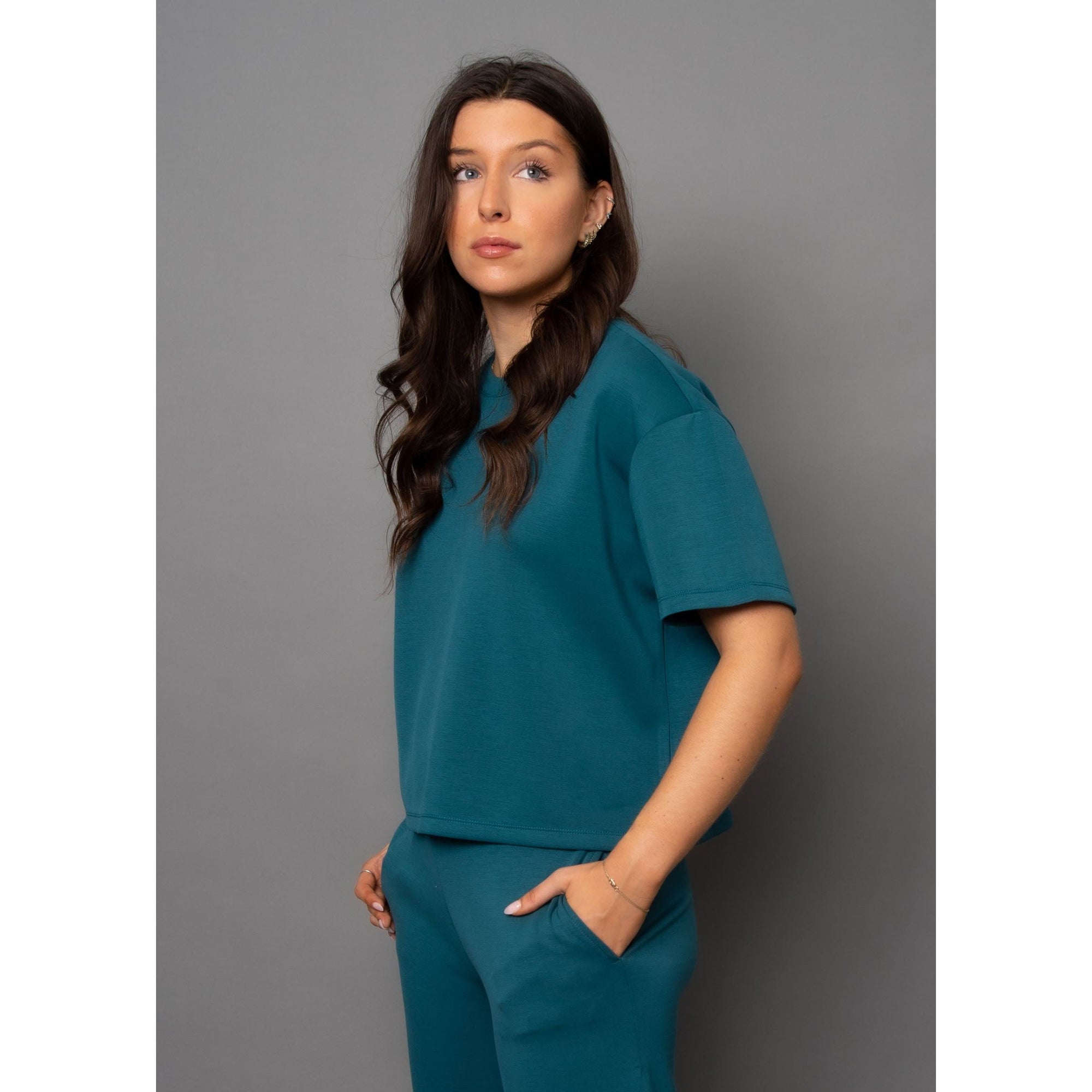 Stylish model showcases the Scuba Tess Soft Knit Top in Trekking Green, perfect for casual outfits or cute sets.