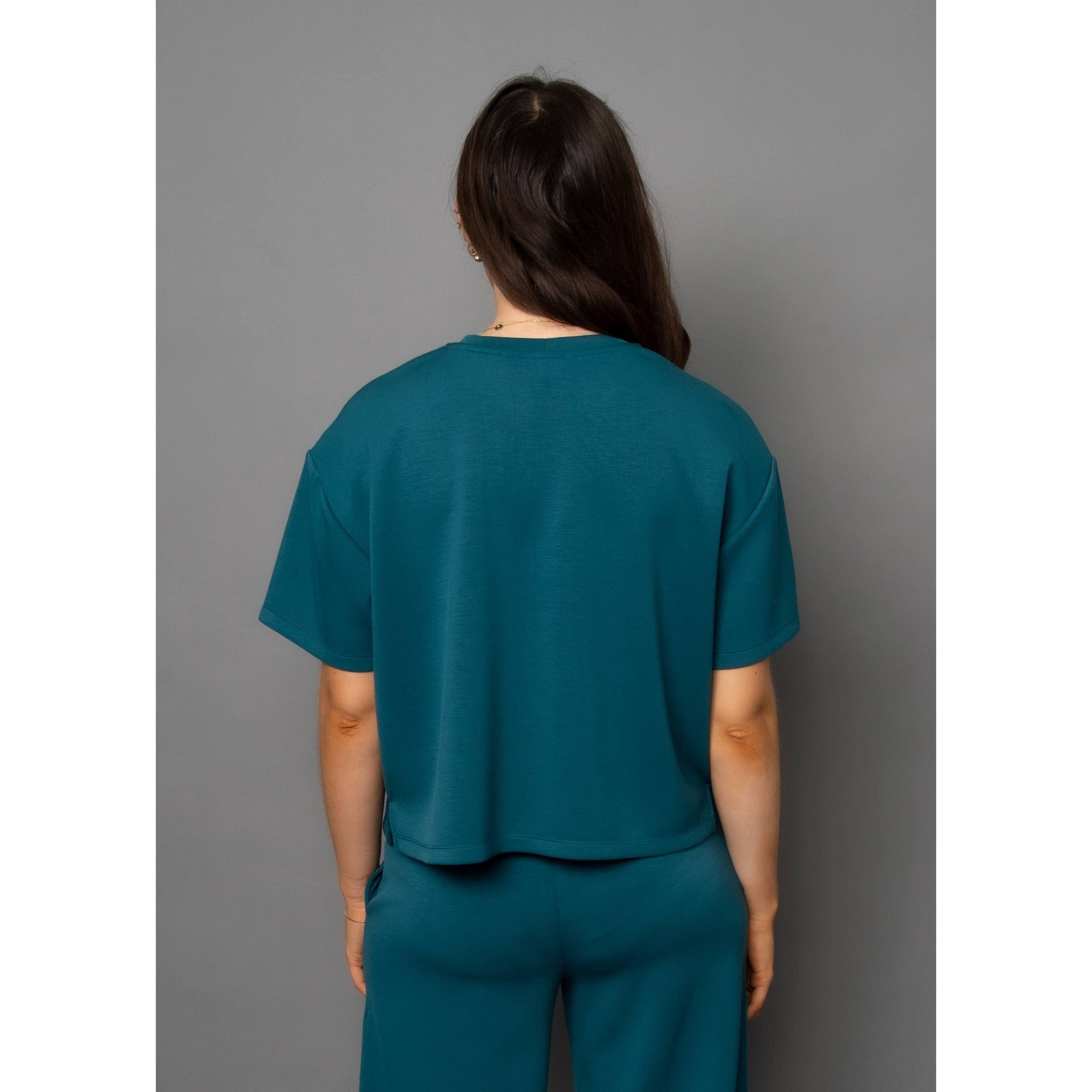 Stylish Scuba Tess Soft Knit Top in trekking green, featuring a relaxed fit for ultimate comfort and versatility.