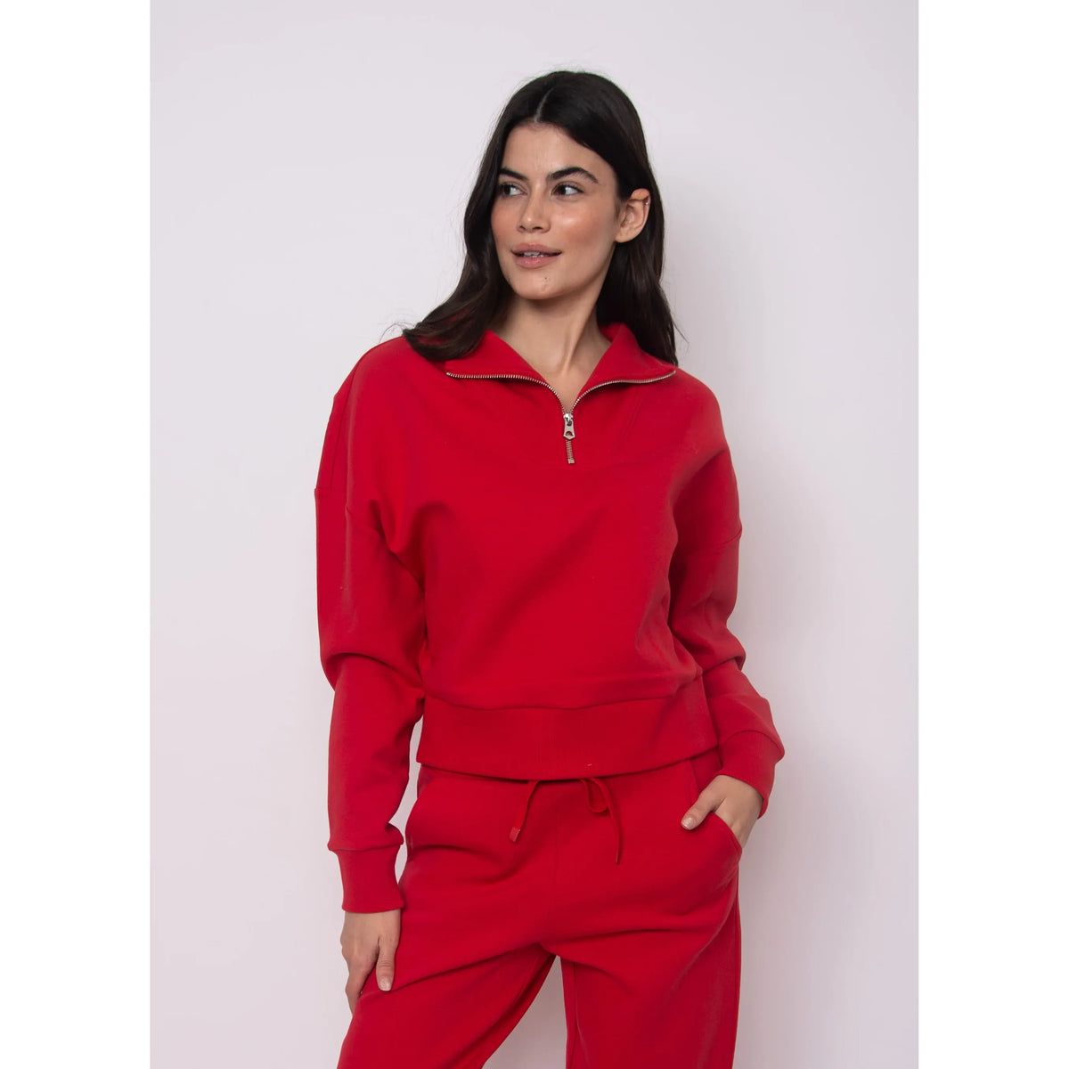 Model wearing Seanni Soft Knit Half Zip Pullover in red; cozy fall knit with zip collar.