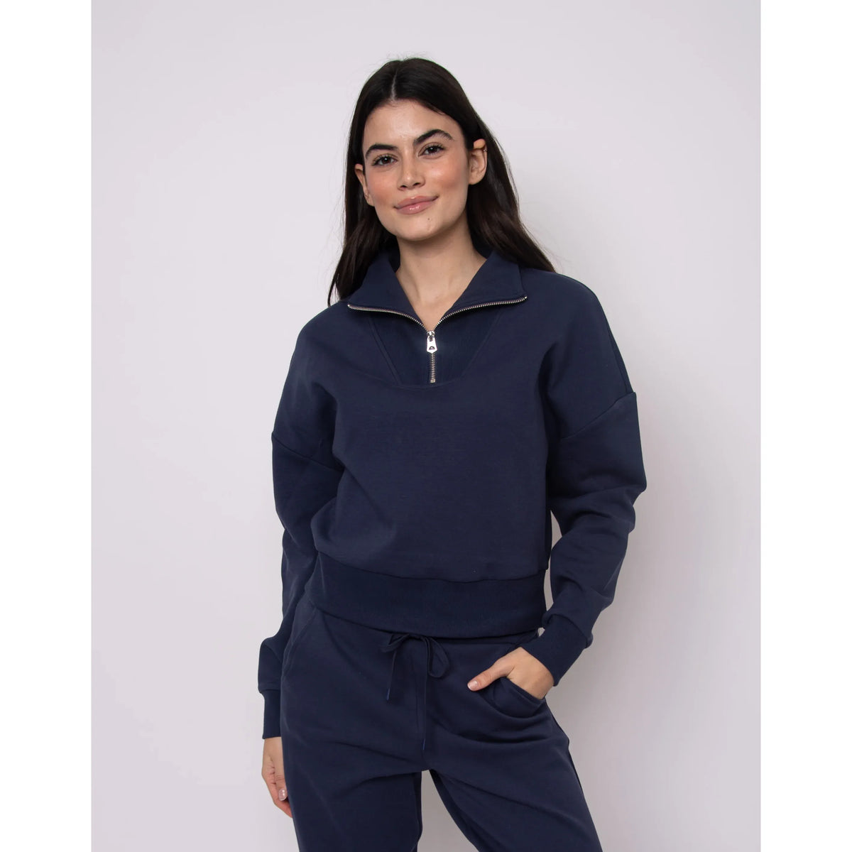 Seanni Soft Knit Half Zip Pullover in navy worn with matching joggers by a model.