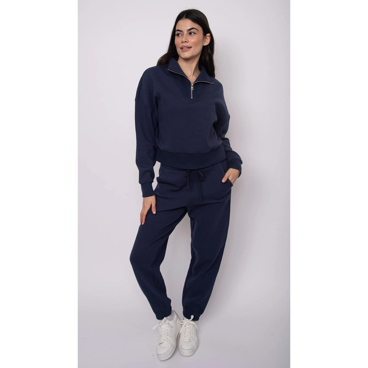 Model wearing navy Seanni Soft Knit Half Zip Pullover with matching joggers, fall-ready cozy outfit.