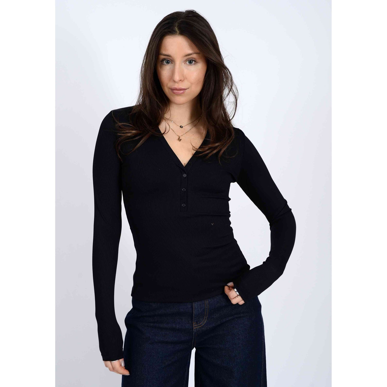Second Skin Helane 23 2x2 Rib Henley black rib knit long-sleeve top on model, flattering silhouette.