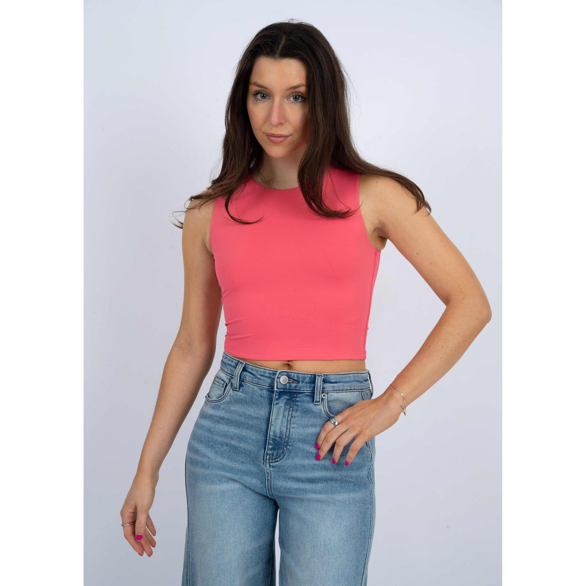 Stylish model wearing the Second Skin Roxanna Crew Neck Tank Top in fresh coral, perfect for everyday comfort.