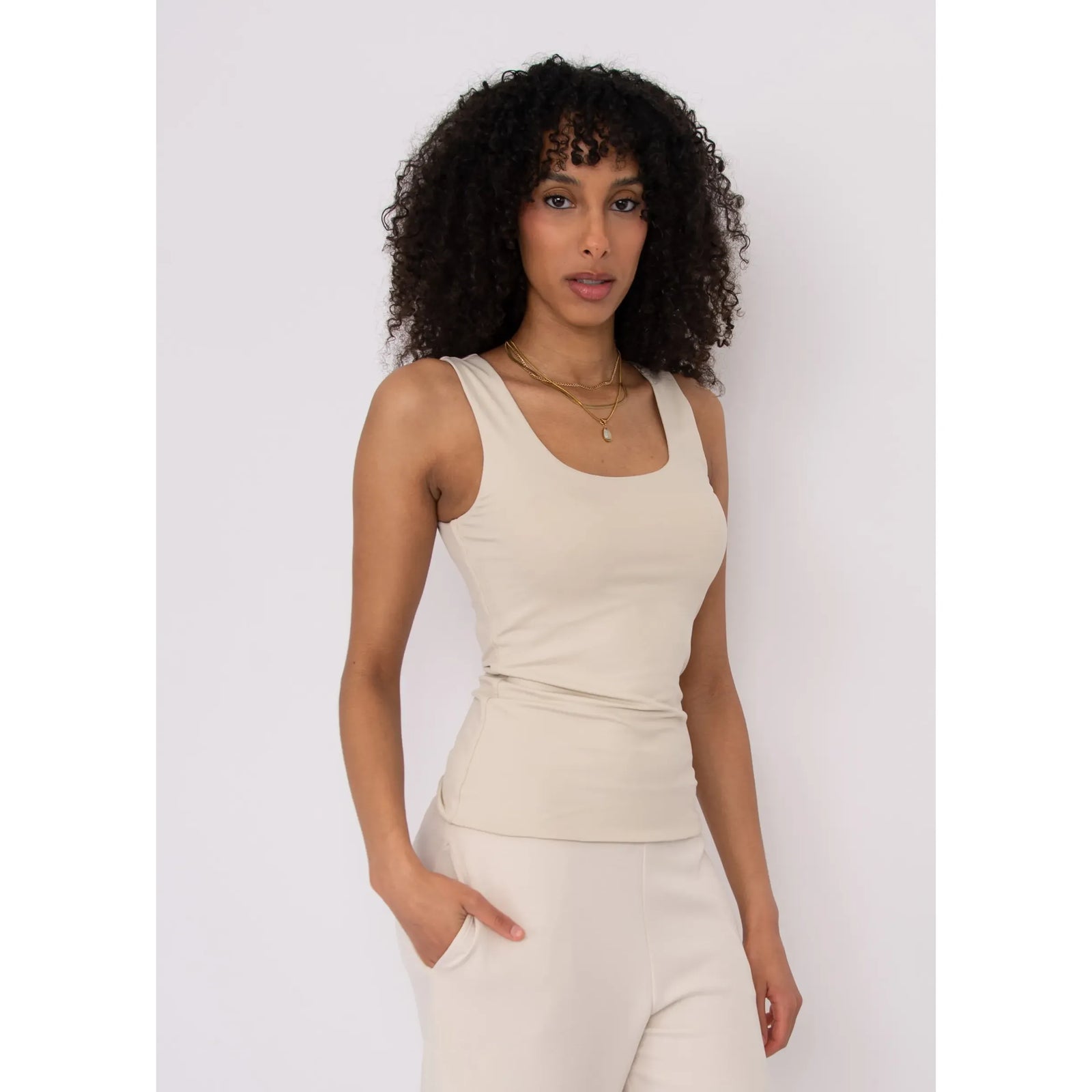 Second Skin Tanith Double Uneck Tank Top in beige, modeled with gold layered necklaces.