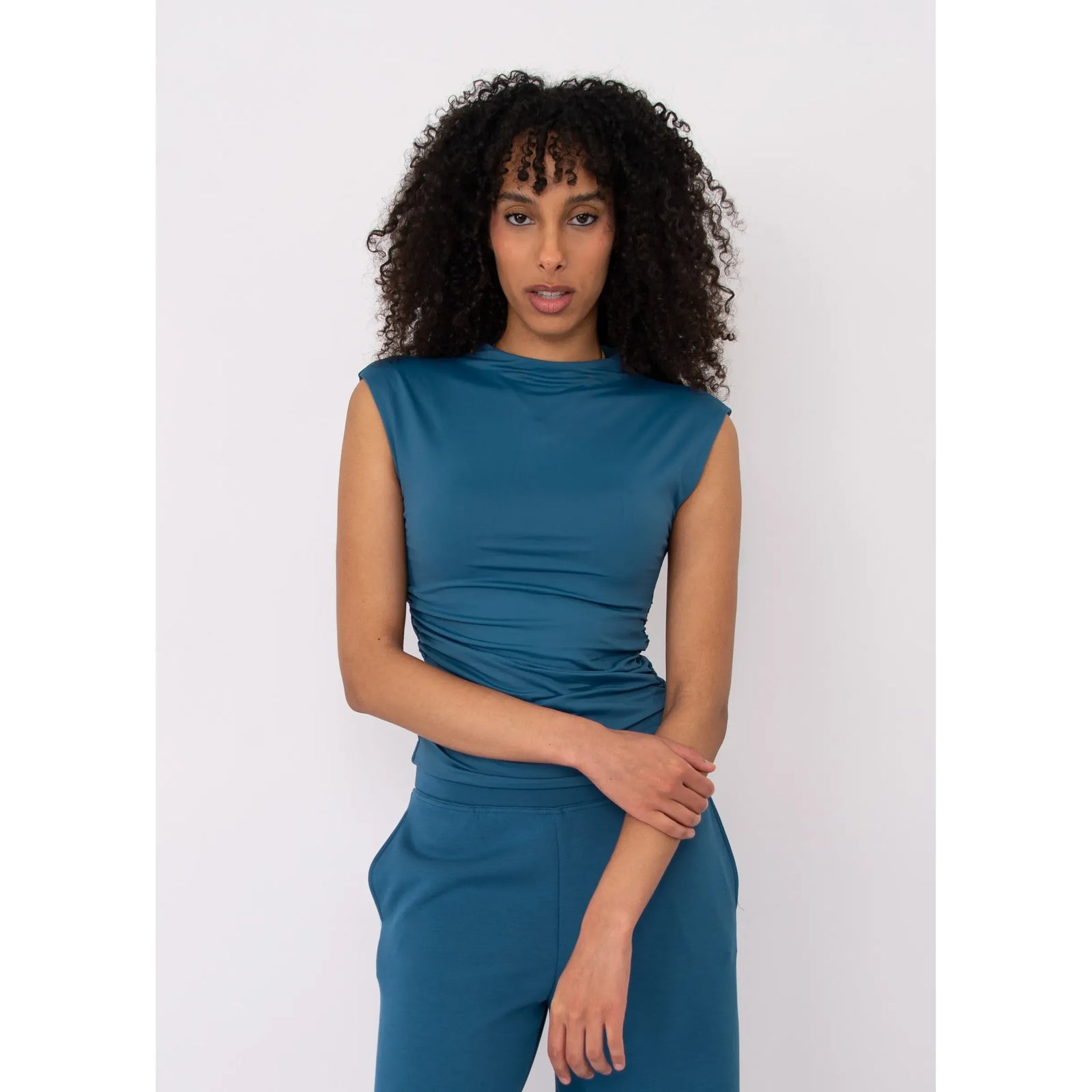 Teal Second Skin Yve Ruched Mock Neck sleeveless top on model with ruched detailing.