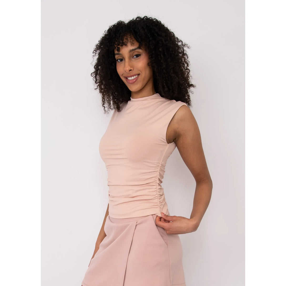 Second Skin Yve Ruched Mock Neck tank in blush pink, worn by model.