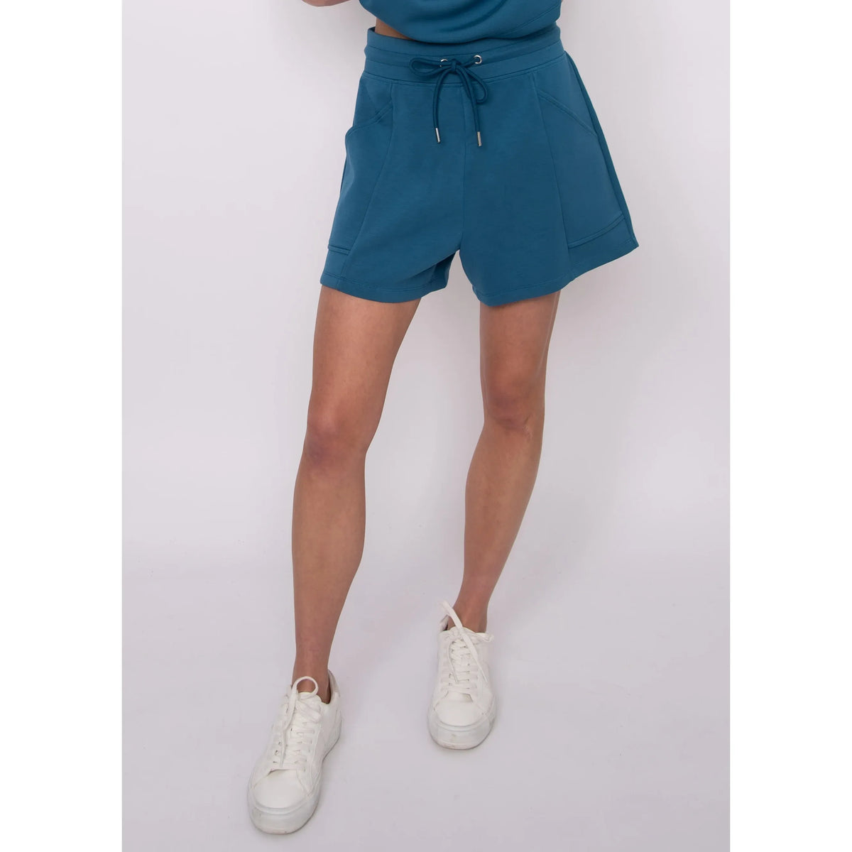 Senza Soft Knit Shorts in teal with pockets and a drawstring waist, worn by Sharlen (5'6"), size small.