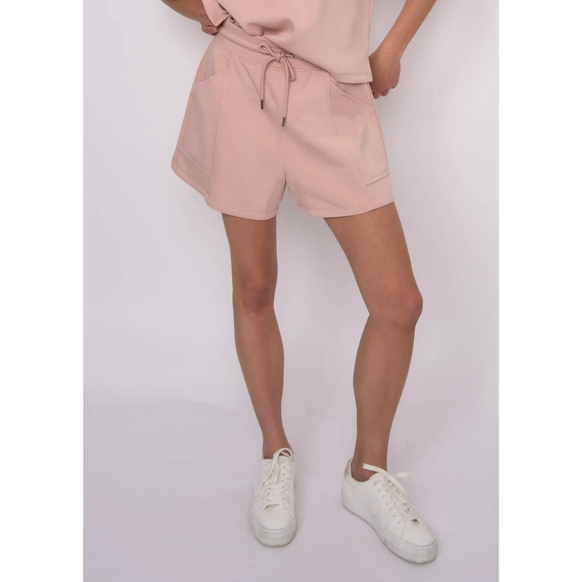 Senza Soft Knit Shorts in blush pink with pockets and drawstring, on a 5 ft 6 in model wearing size small.