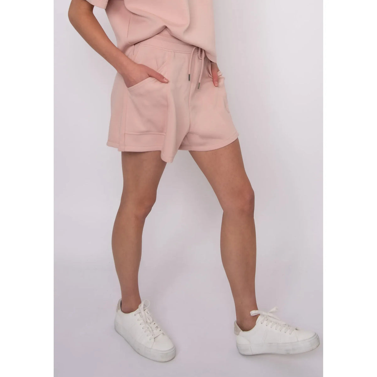Senza Soft Knit Shorts in blush pink with pockets and drawstring; model Sharlen in size small, matching top available.