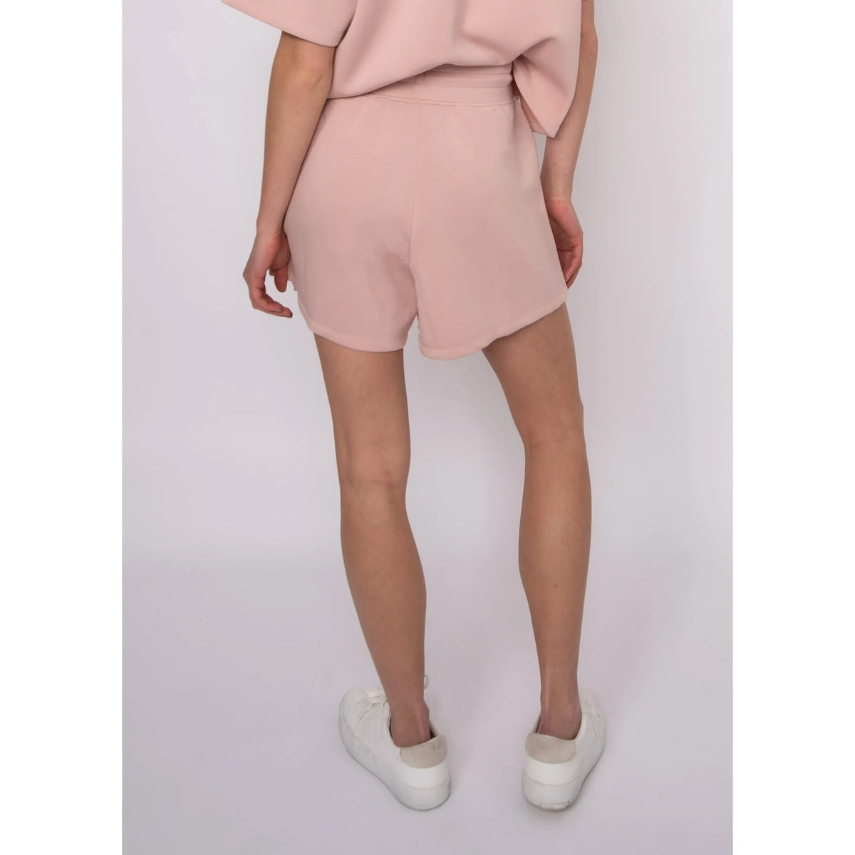 Senza Soft Knit Shorts in blush pink, back view with elastic waistband and pockets, worn by Sharlen (5'6", size small).