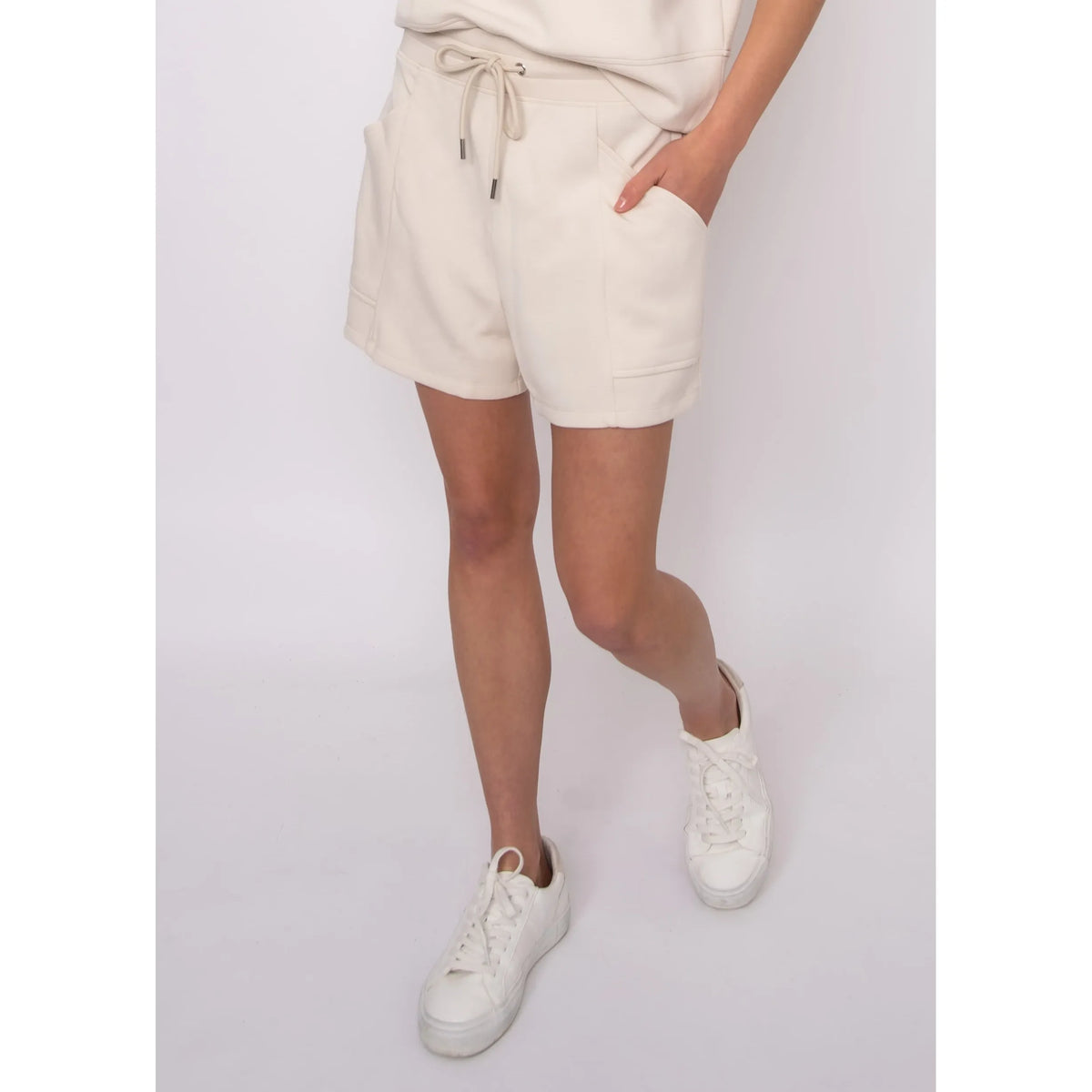 Senza Soft Knit Shorts in cream with pockets and drawstring, worn by Sharlen (5 ft 6, size small) for a casual lounge look.
