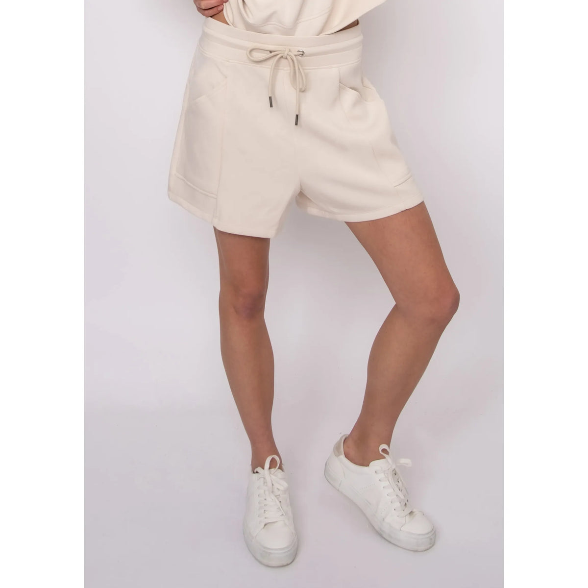 Senza Soft Knit Shorts on model Sharlen (5 ft 6 in, size small): beige knit lounge shorts with pockets and drawstring.