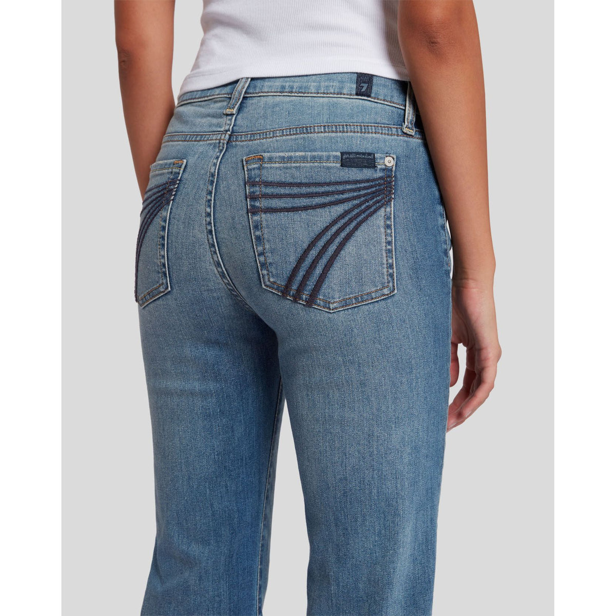 7 for all Mankind Dojo Slim Illusion jeans, back view showing curved navy arc embroidery on pocket