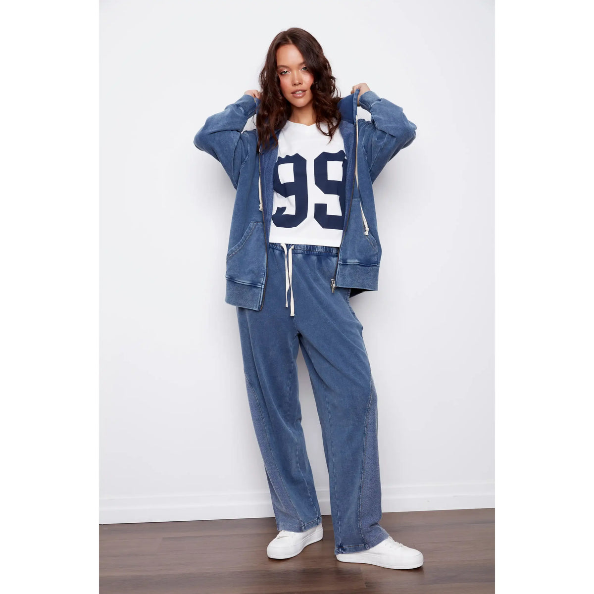 Model in acid-wash blue Silco French Terry Pull On Drawstring Pants with a relaxed wide-leg silhouette.