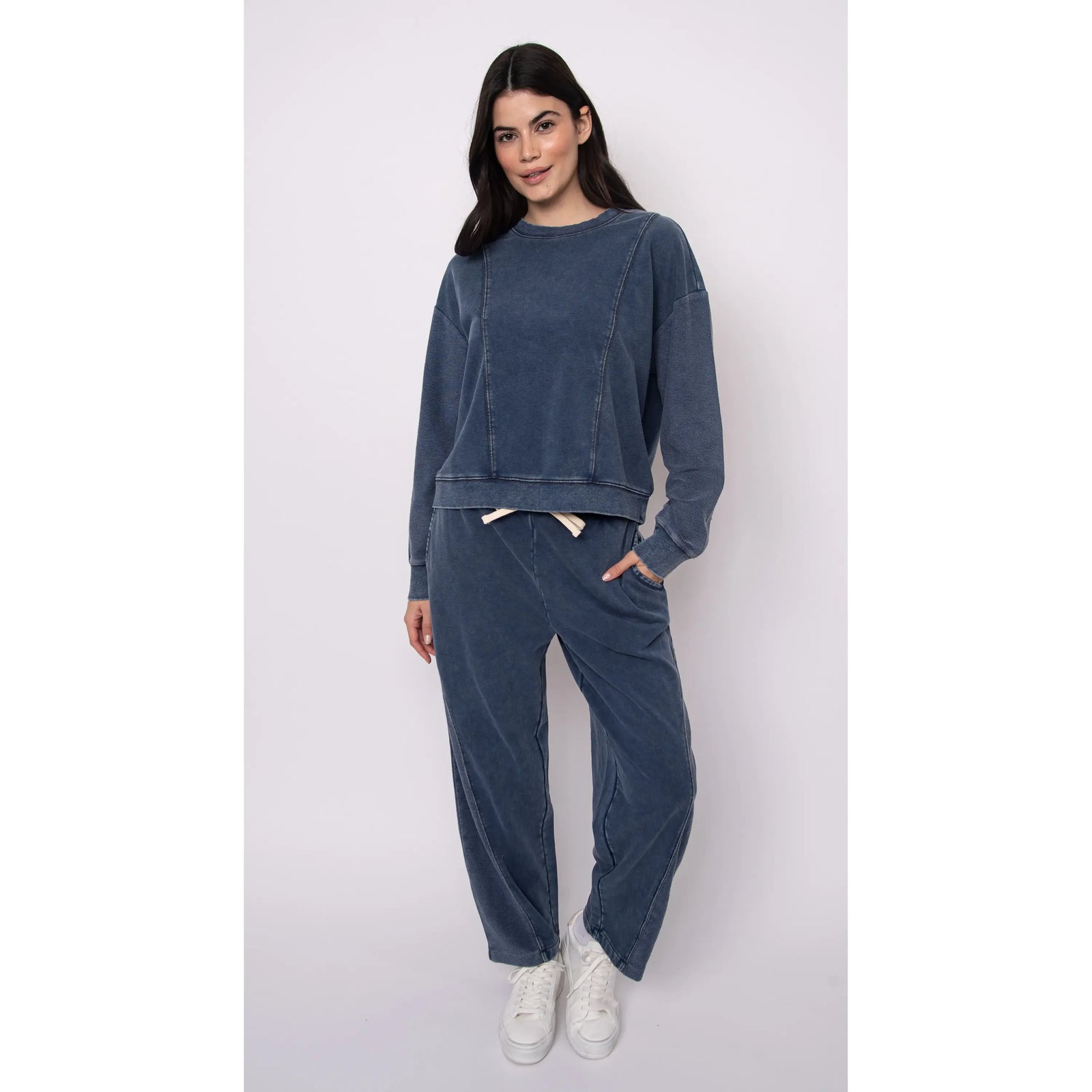 Model wearing Silco French Terry pull-on drawstring pants in blue with acid-wash finish and relaxed wide-leg silhouette.