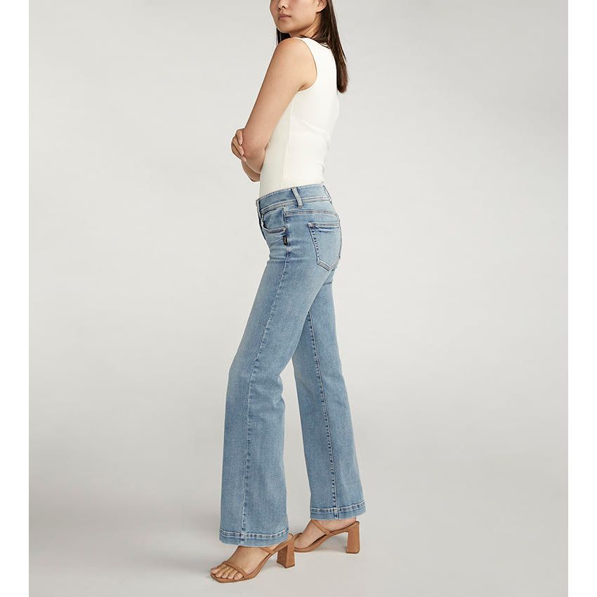 Silver Suki Trouser in Indigo denim on a model; power-stretch, mid-rise, flared-leg jeans, comfortable fit.