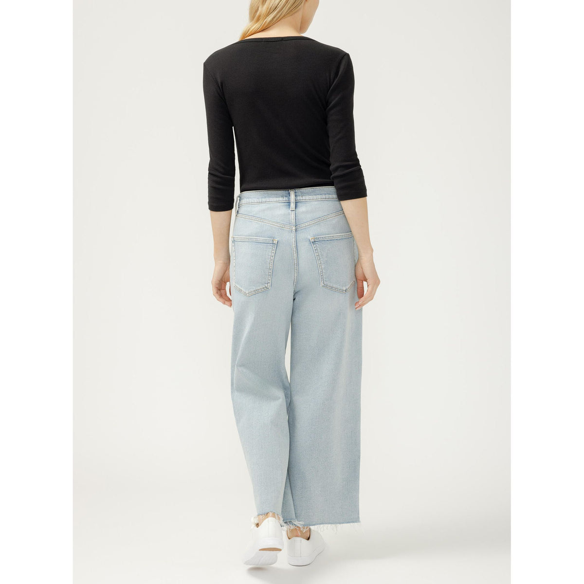 Silver Be Easy wide-leg crop jeans in Malaga on model, back view in light-wash denim.