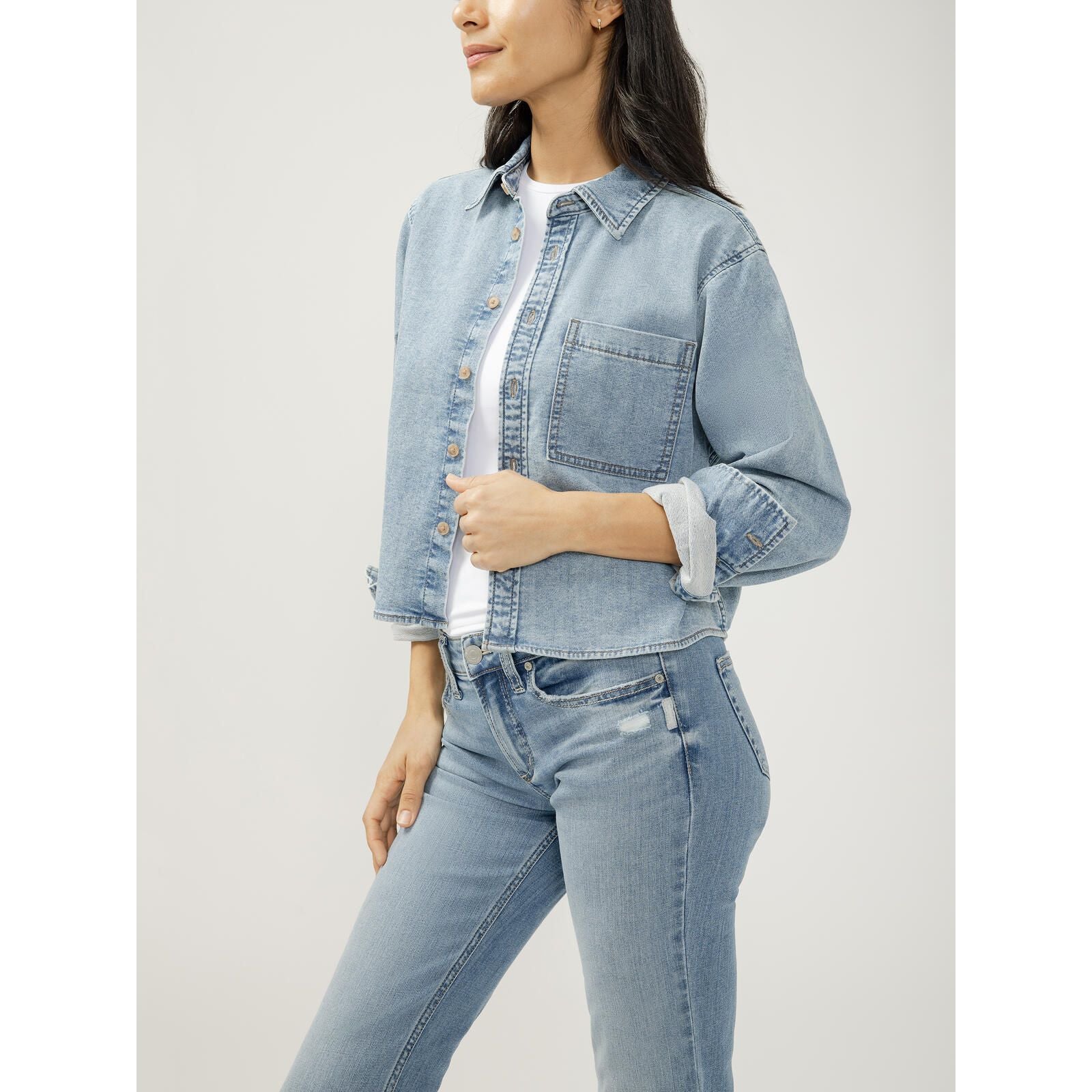 Women's silver jeans button front knit flex shirt. Classic cropped denim shirt with relaxed shape and single chest pocket.