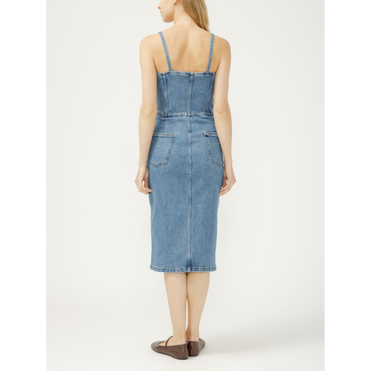 Back view of a light-blue denim midi dress with adjustable spaghetti straps and back pockets.