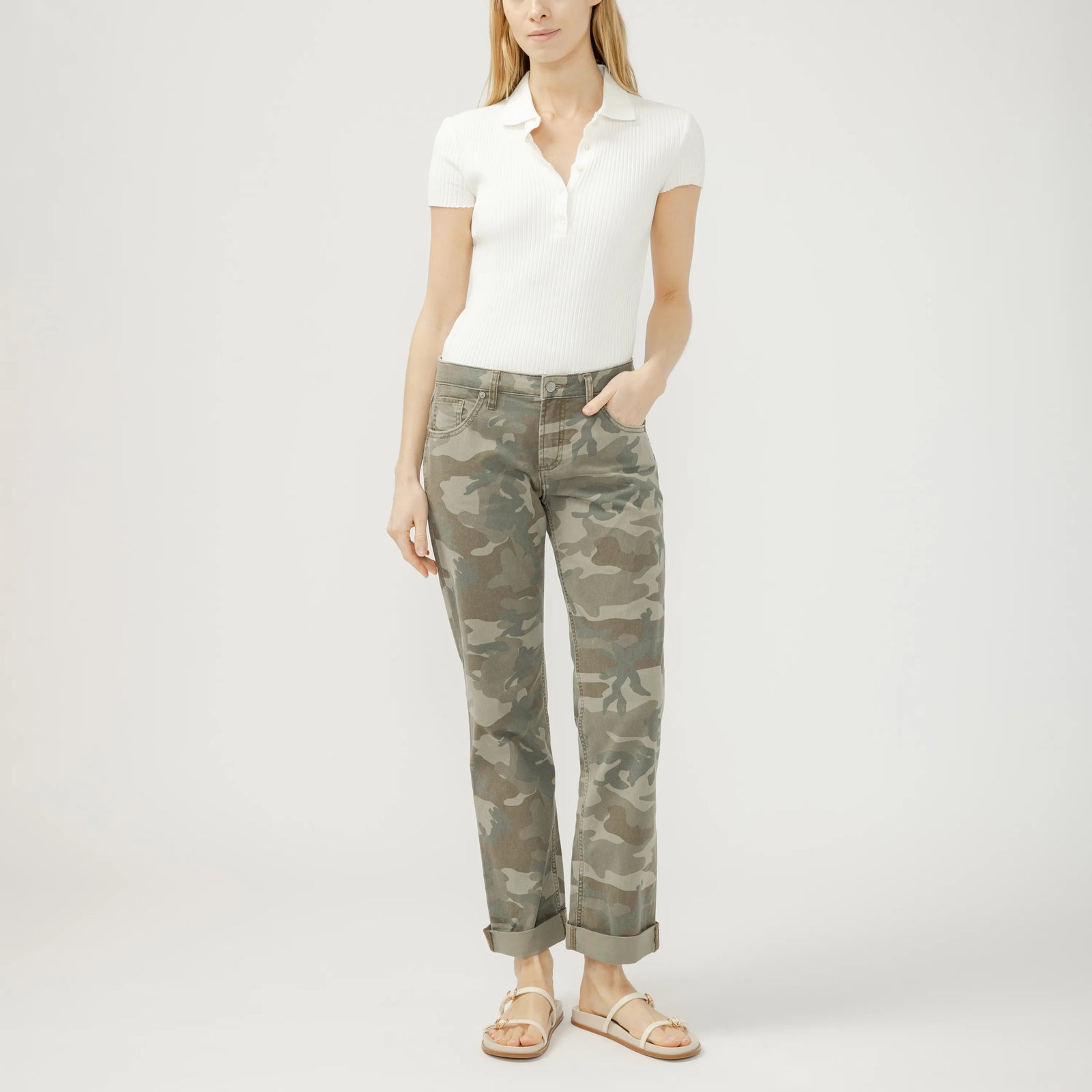 Model wearing Silver Chelsea Boyfriend jeans in camo with cuffed hems and a white ribbed polo.