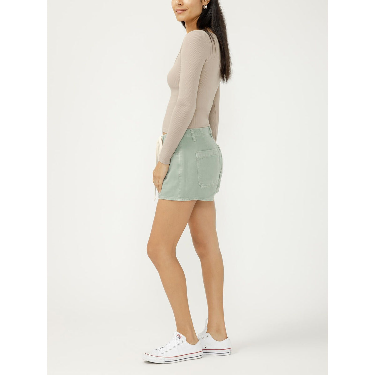 Model wearing Silver Drawstring Beach Short in light green denim with a drawstring waistband and beige rib-knit top.
