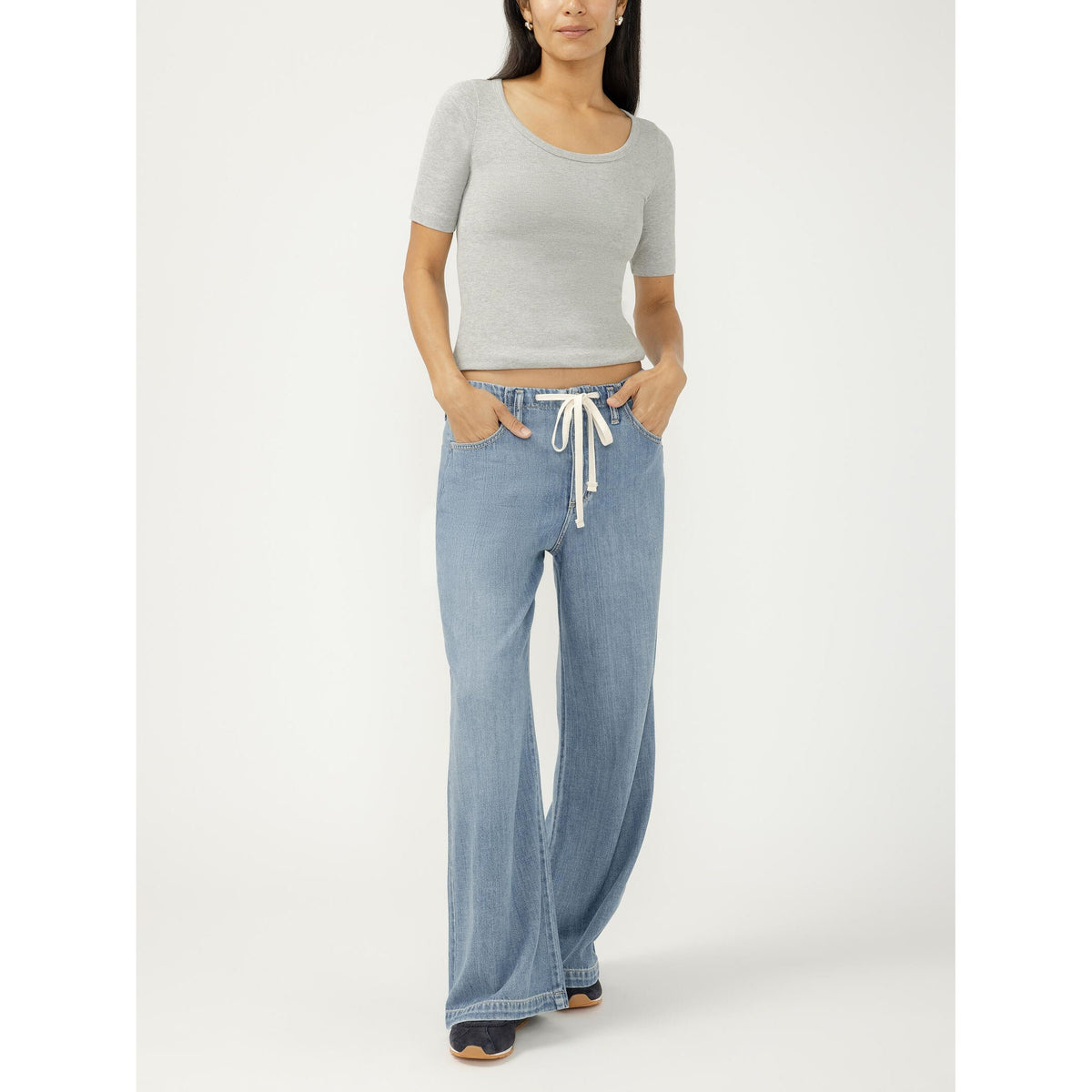 Wide-leg drawstring denim beach pants in a medium indigo wash with a relaxed fit.