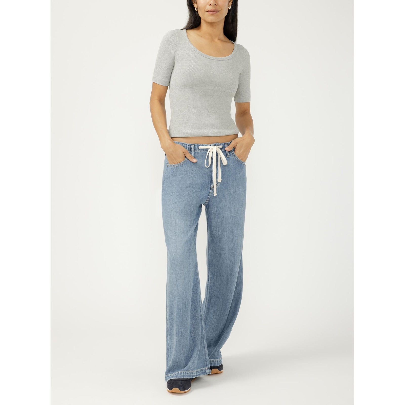 Wide-leg drawstring denim beach pants in a medium indigo wash with a relaxed fit.