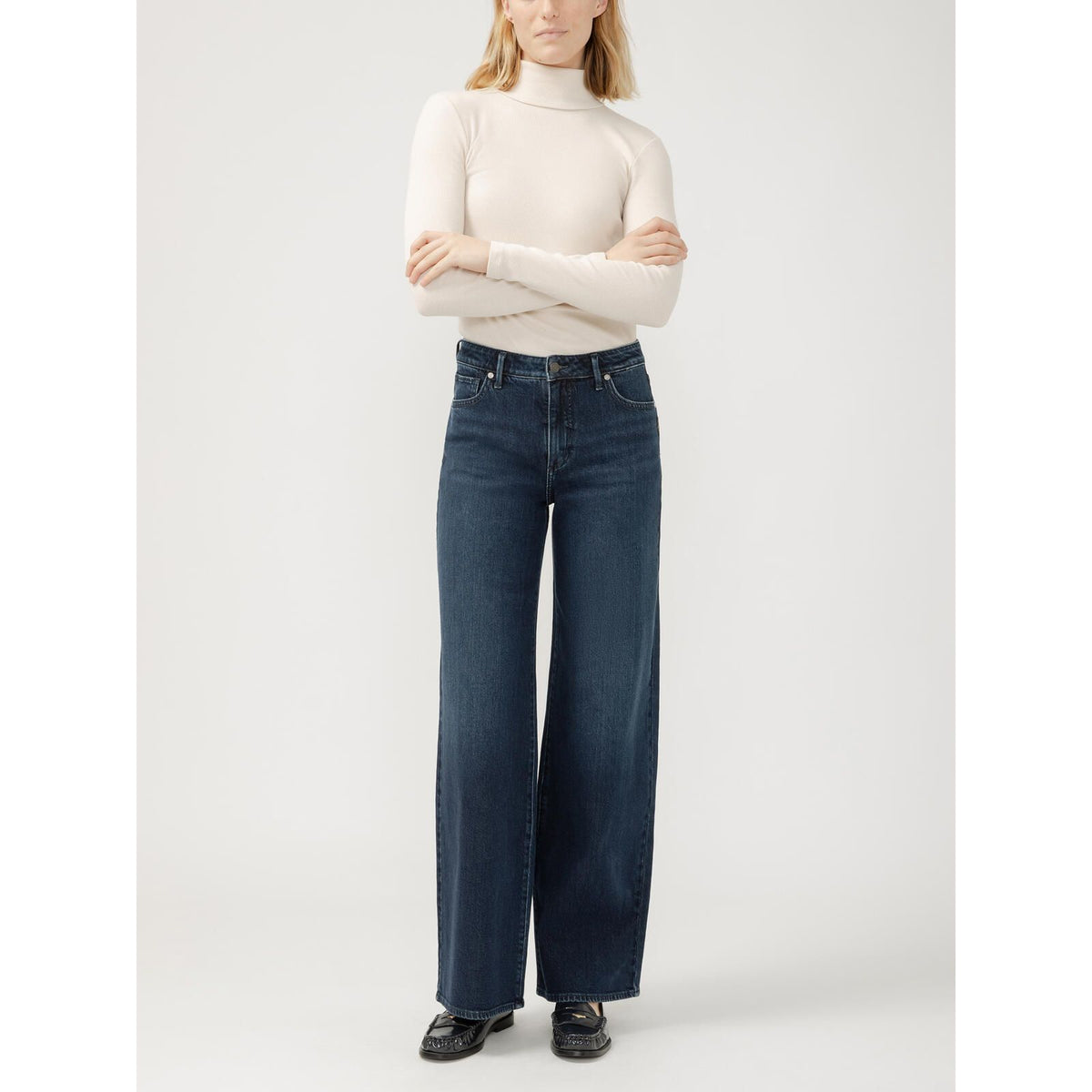 Silver Isbister Wide Leg Denim in Bijou, all-day comfort, model in a cream turtleneck.