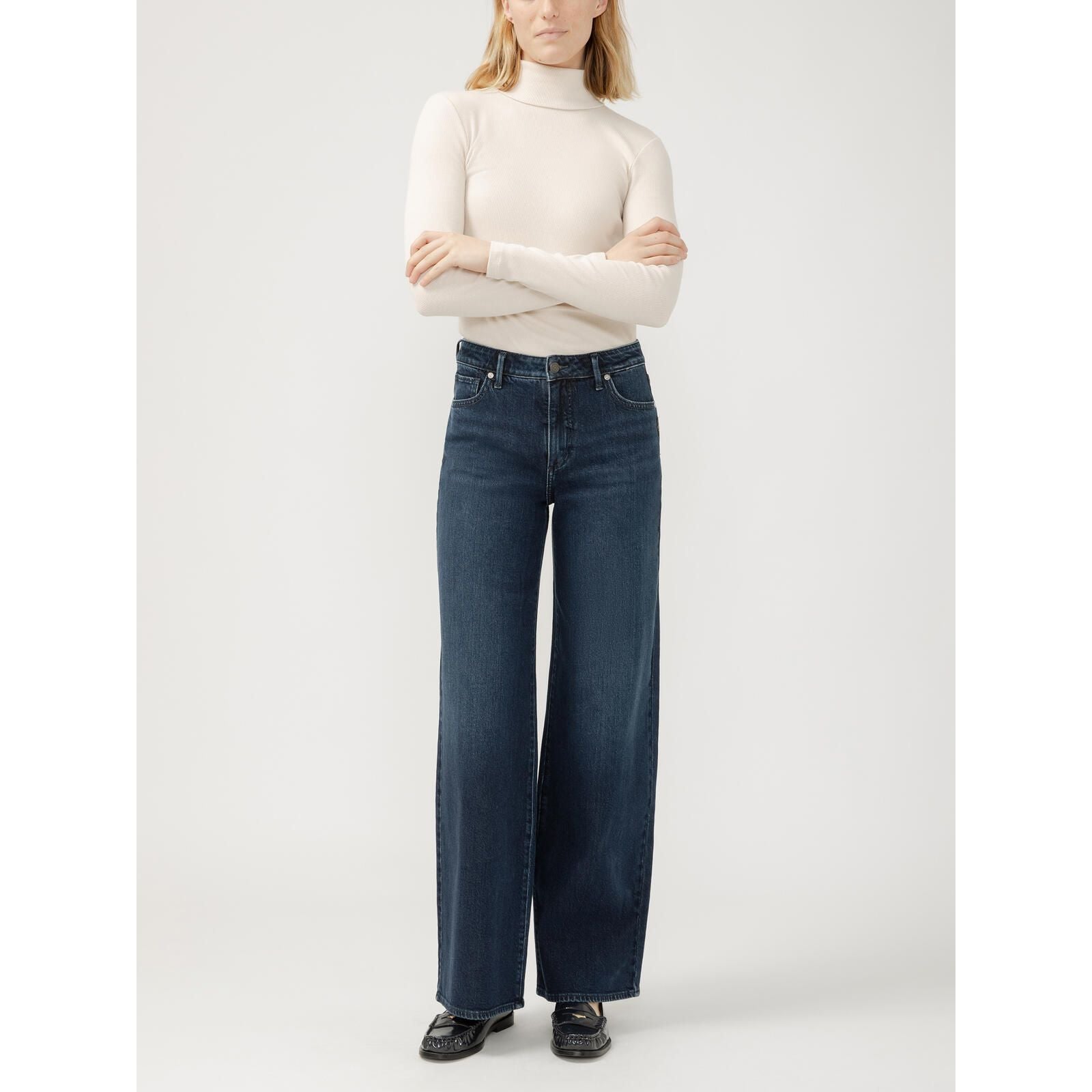 Silver Isbister Wide Leg Denim in Bijou, all-day comfort, model in a cream turtleneck.
