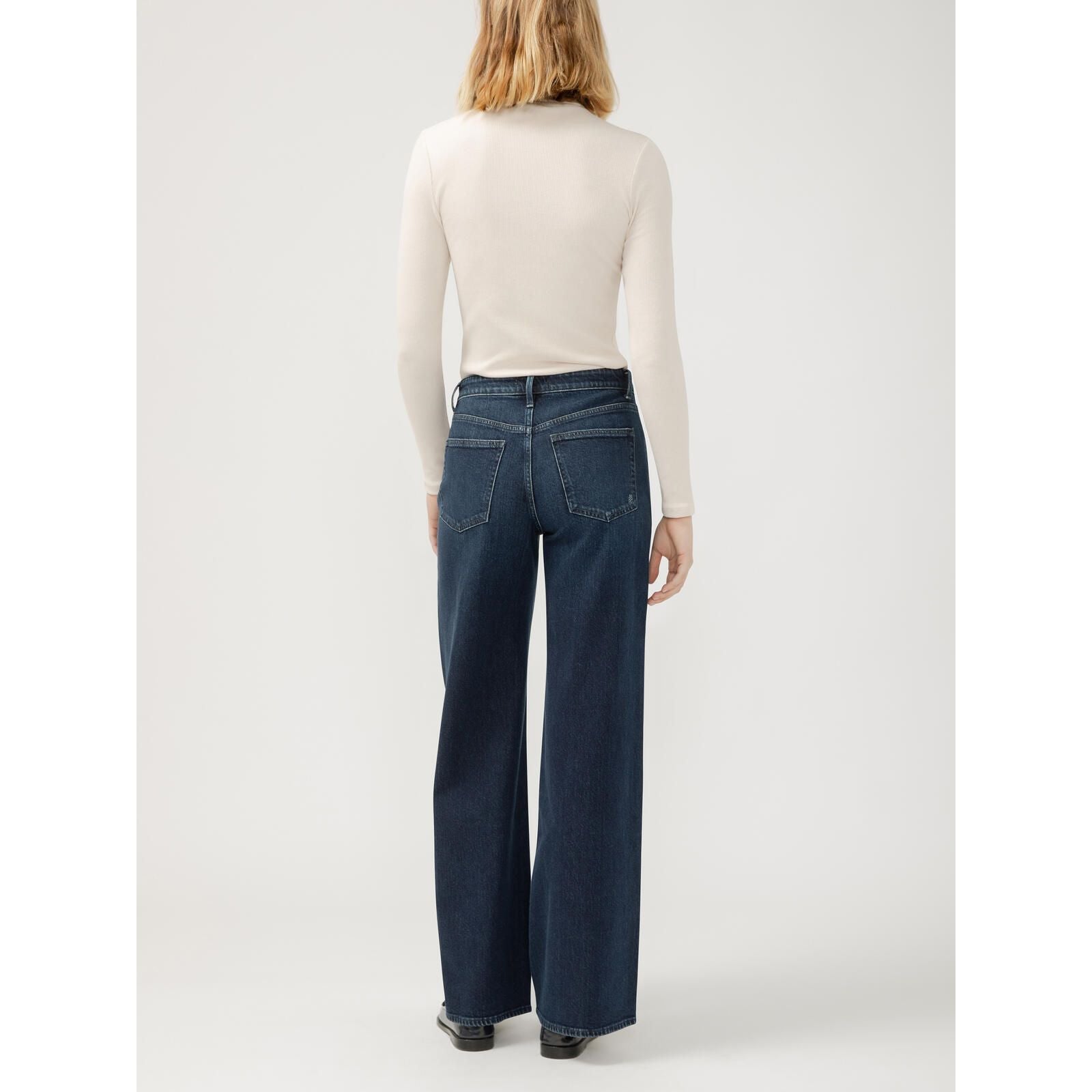 Silver Isbister Wide Leg Denim in Bijou, all-day comfort, model in a cream turtleneck.