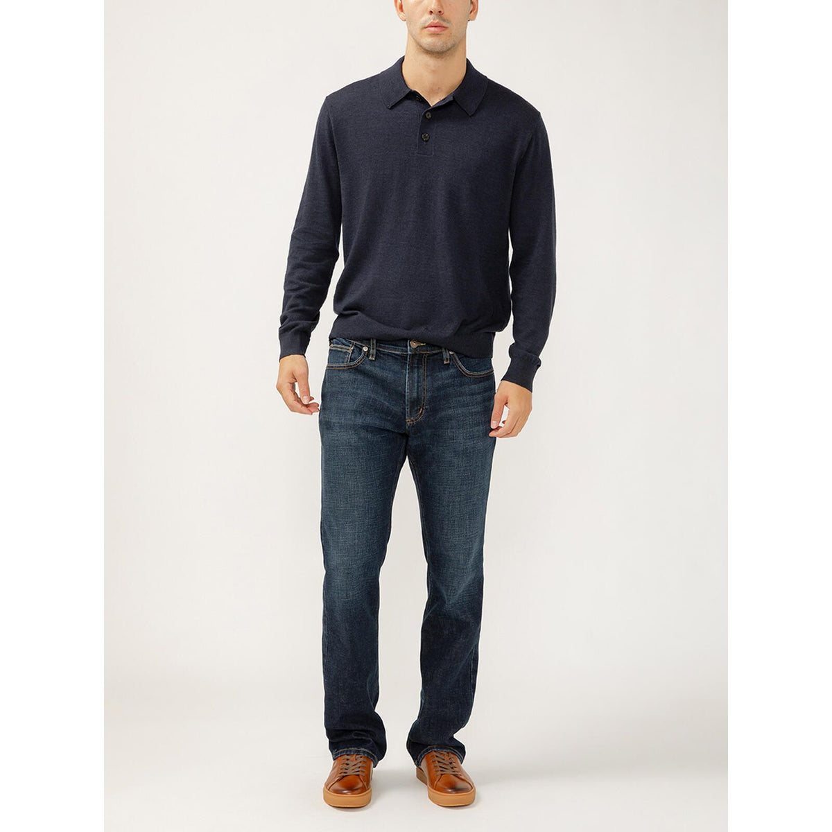 Model wearing navy knit polo and Silver Jace Slim Bootcut Luxe in Swing jeans in Luxe Heritage denim, tan shoes.